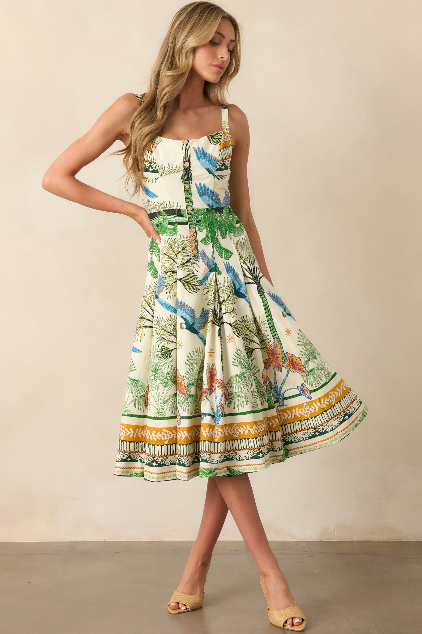 Full-length photo emphasizing the flow of the pleated skirt and vibrant tropical pattern.