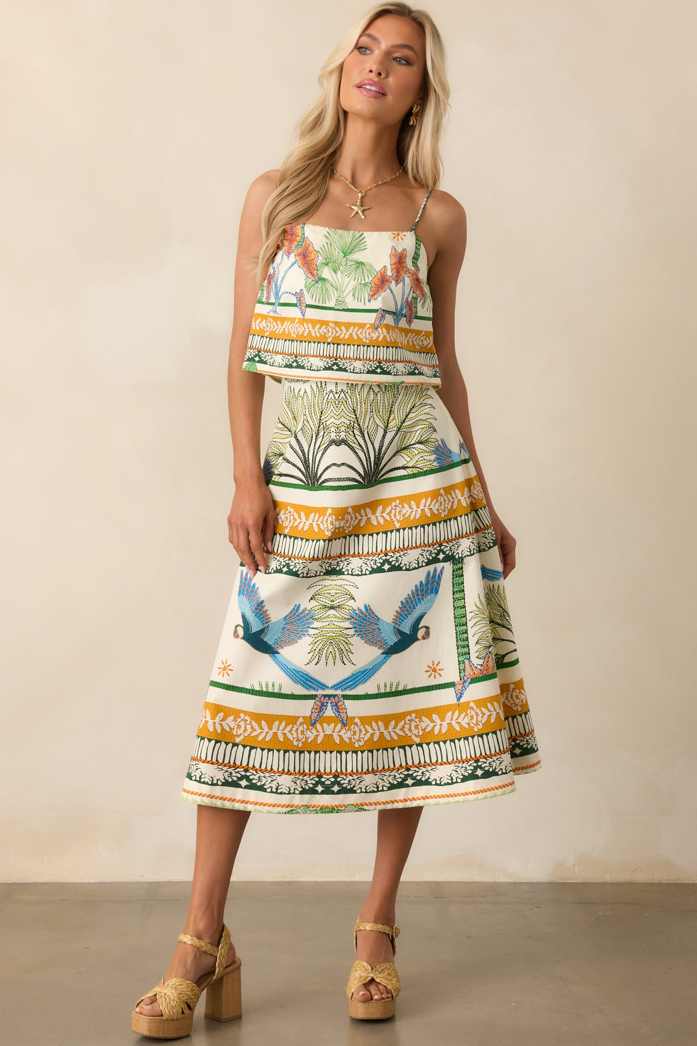 Front-facing full body shot emphasizing the structured shape and vibrant tropical pattern of the skirt.