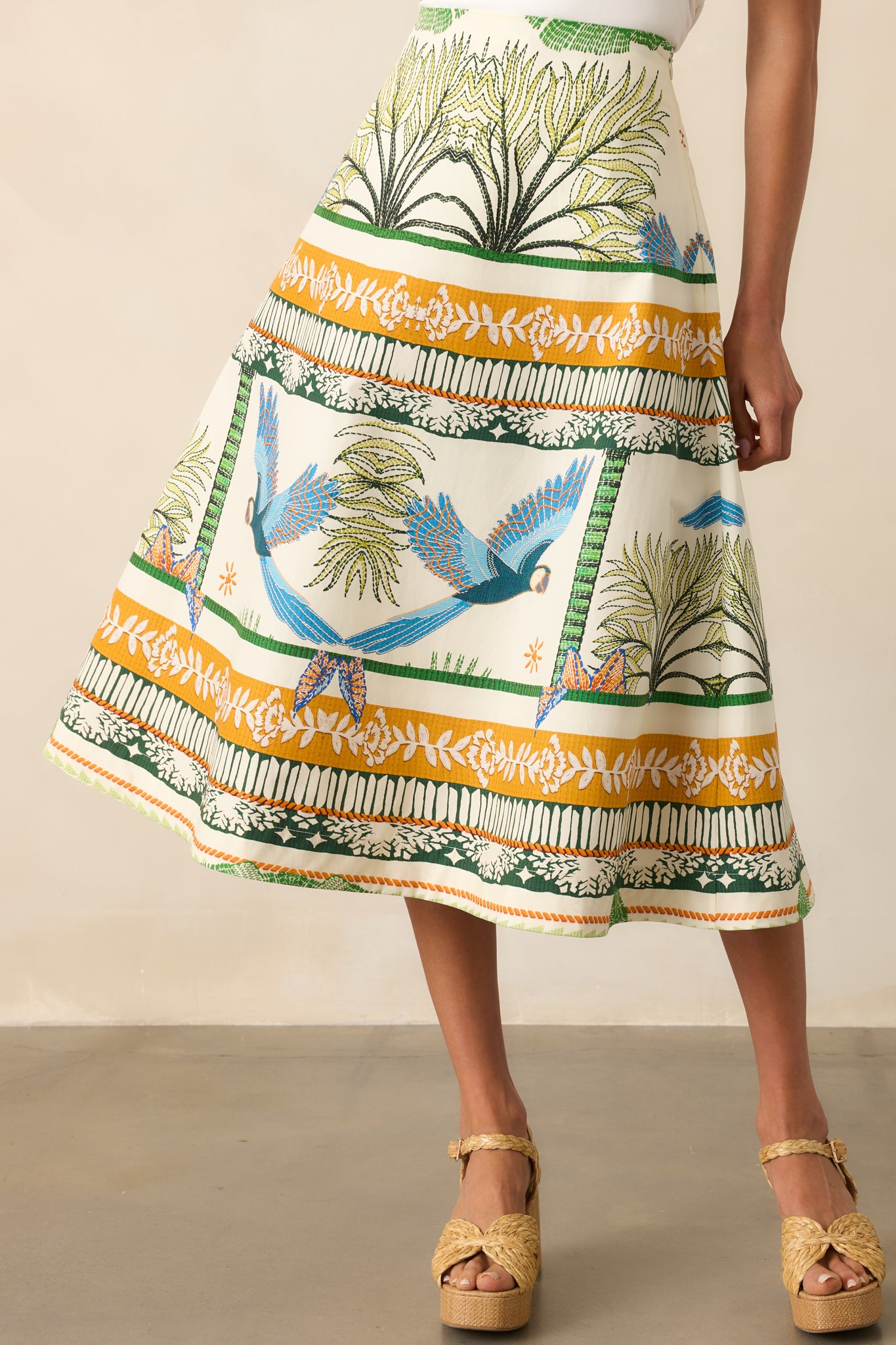 Cropped image focused on the waistband, showing the high-rise fit and the beginning of the tropical print.