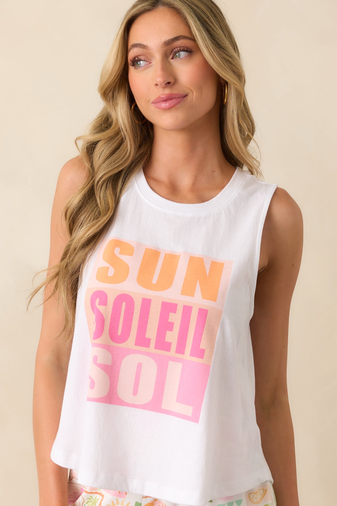 Full view of white sleeveless tank top with a scoop neckline and relaxed fit.