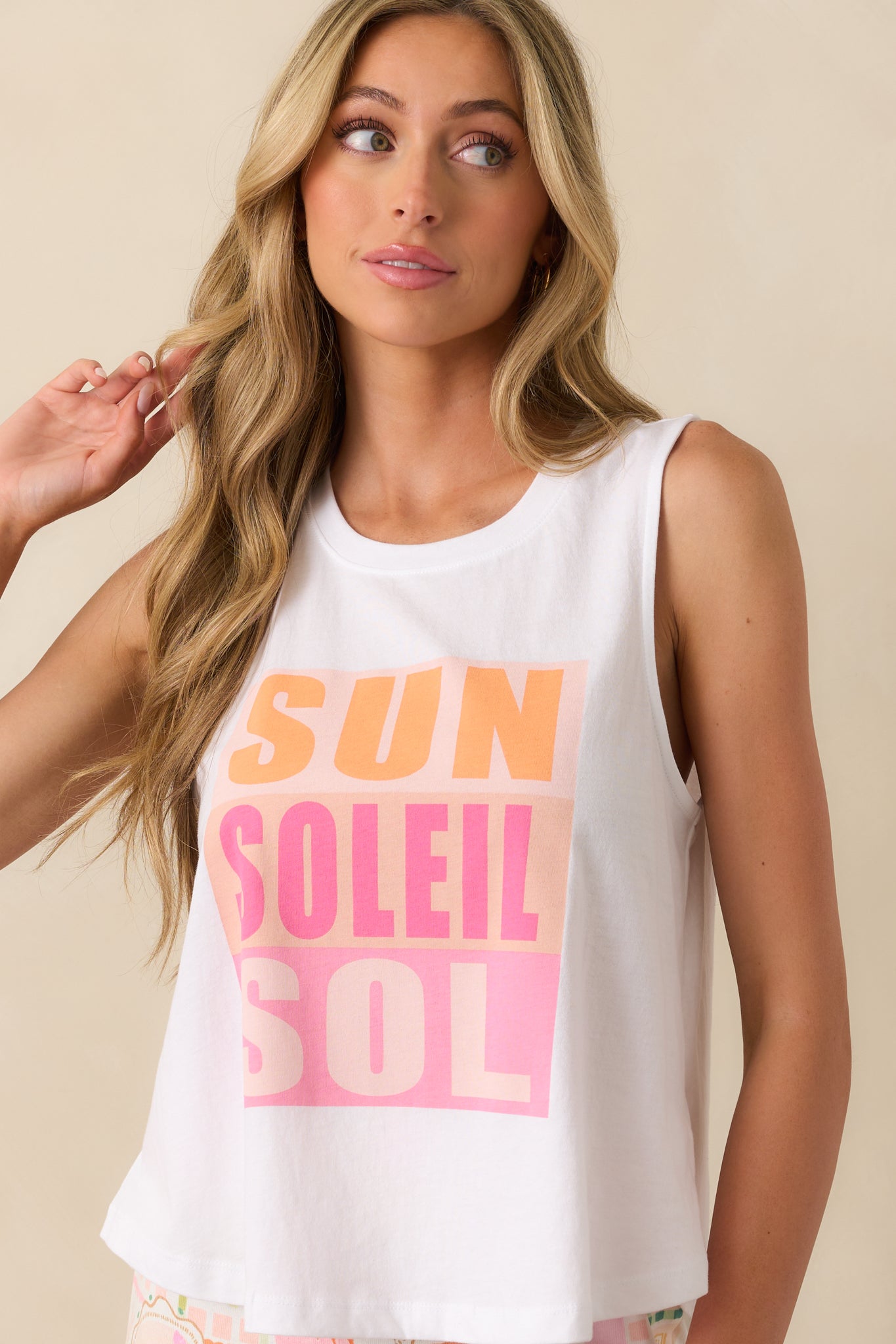 Close crop of the lower front hem area, showing part of the graphic print and fabric drape.