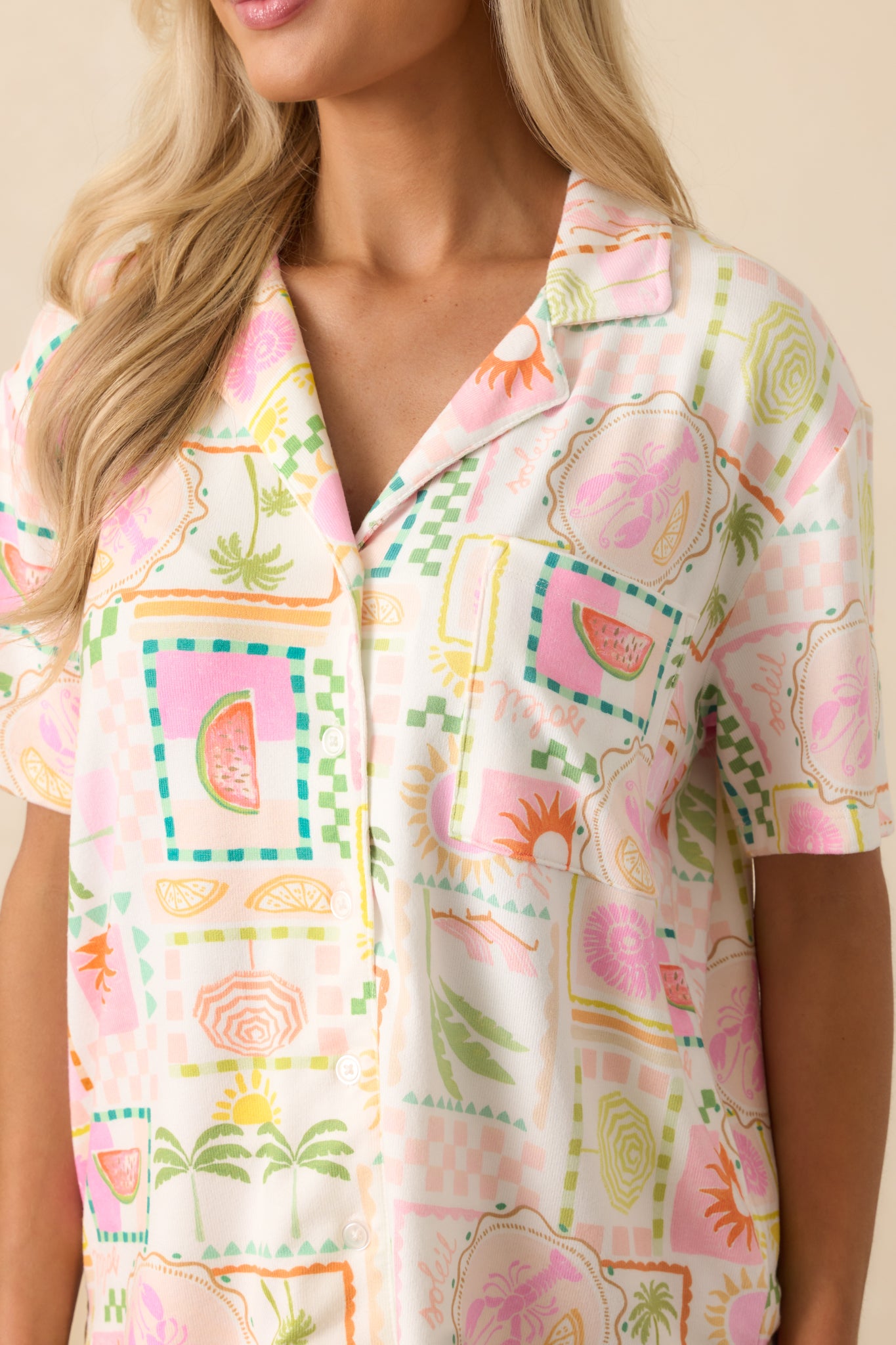 Close-up of the tropical print fabric, highlighting the button front and detailed stitching.