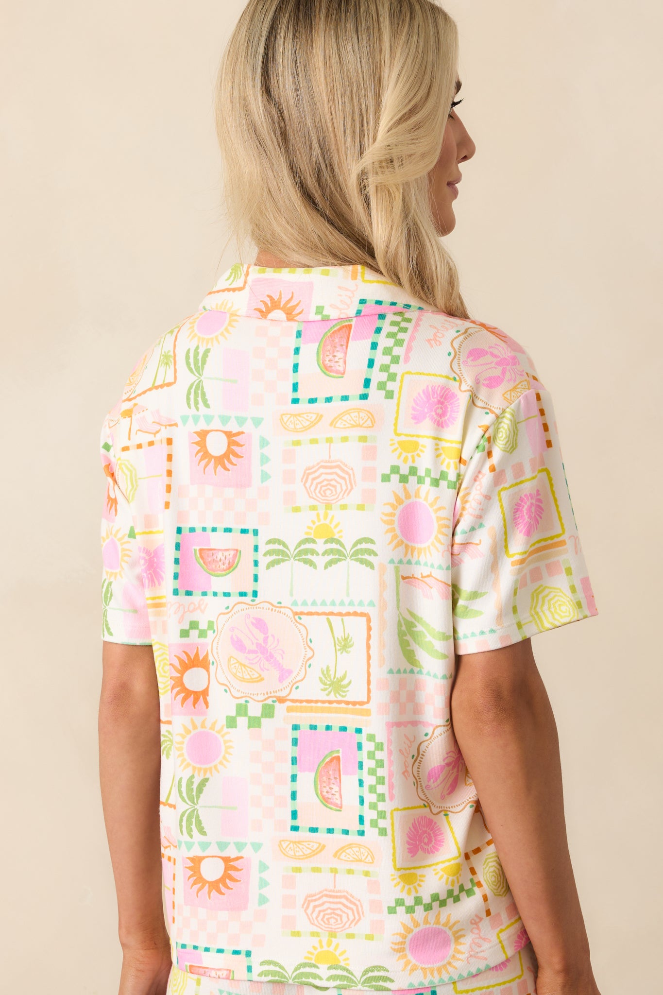 A view from behind of the vibrant tropical print top, showing the collar and relaxed fit.