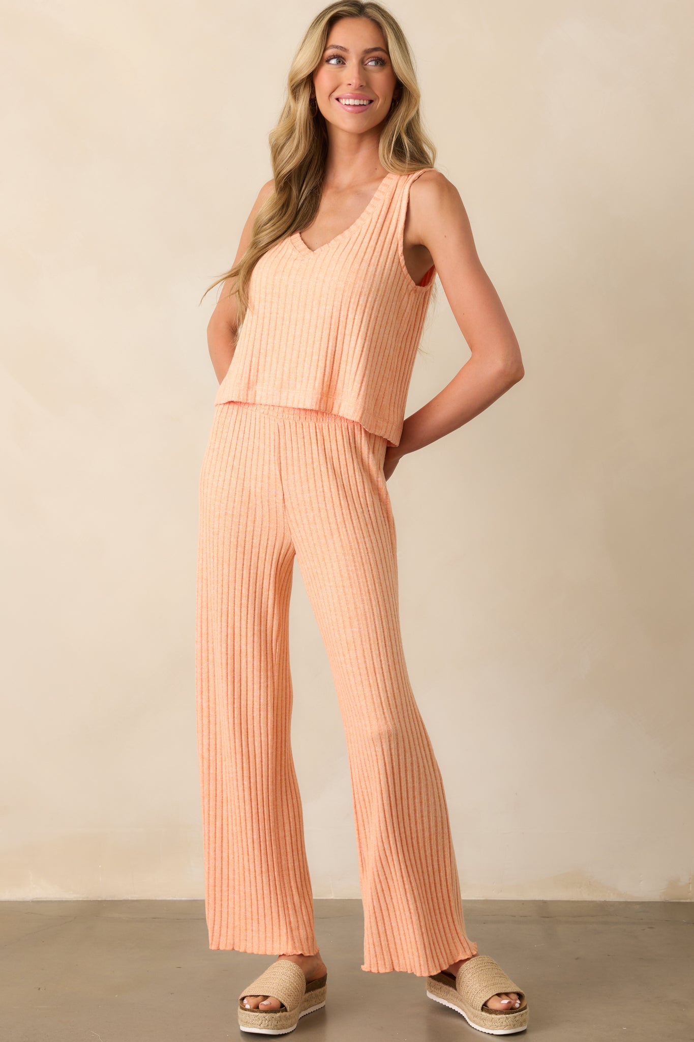 Orange ribbed crop top in a full view, featuring wide straps and a flattering V-neck.