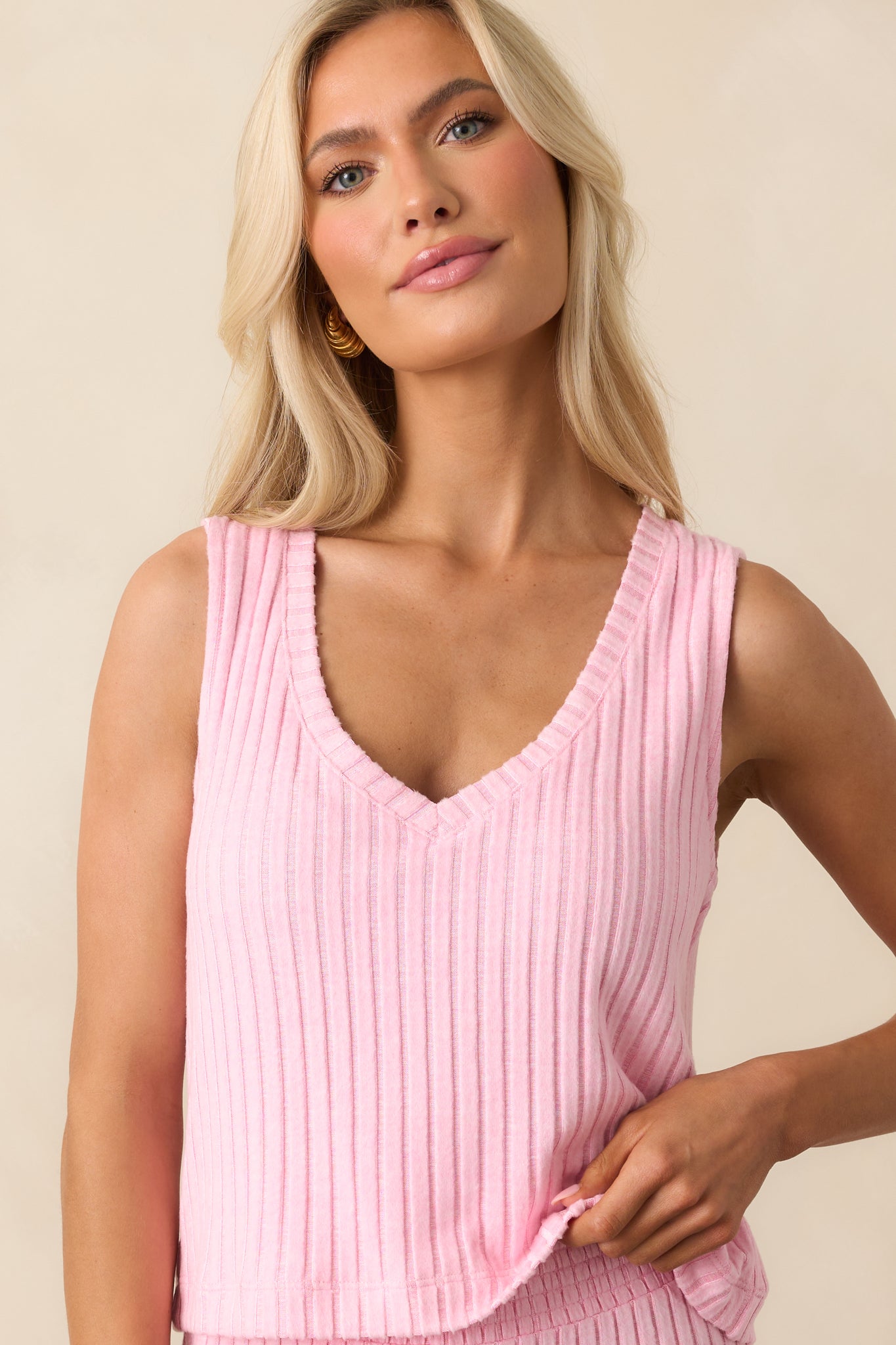 Cropped view of the neckline and upper straps, emphasizing the V-neck and ribbed fabric detail.