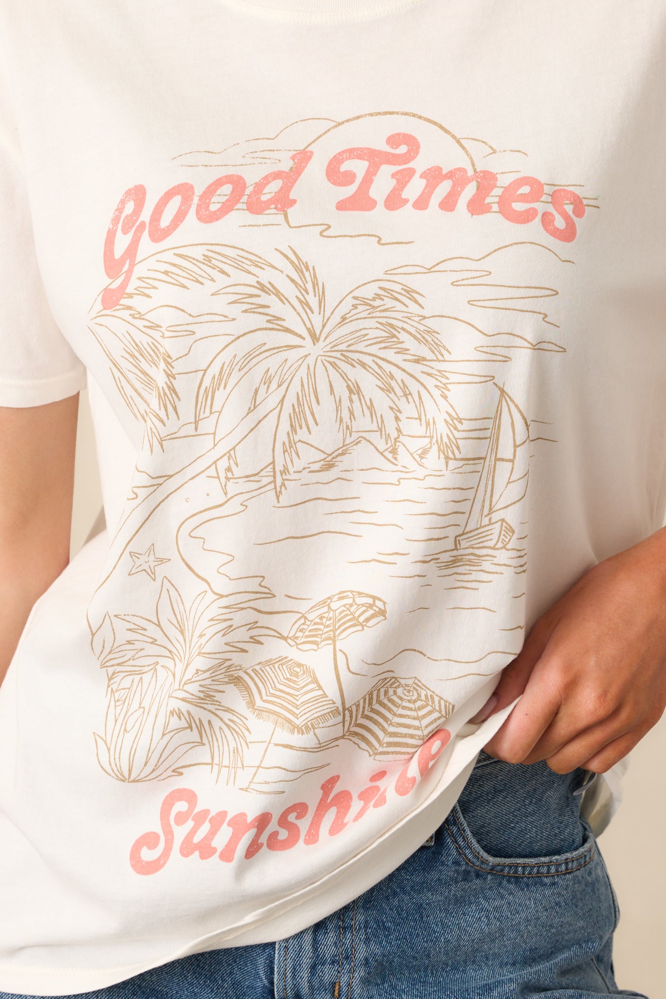 Close-up detail of the ivory tee’s beach graphic, showcasing colors, linework, and print quality