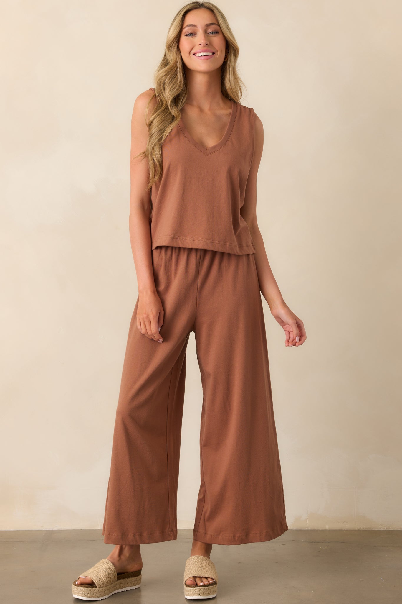 Relaxed-fit brown pants crafted from lightweight cotton jersey, showing a high-rise waist and loose leg shape.