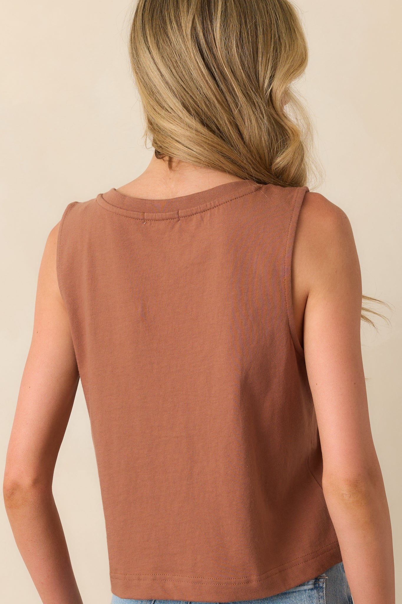 Rear view of the brown tank top showing the sleeveless design and straight cropped hemline.