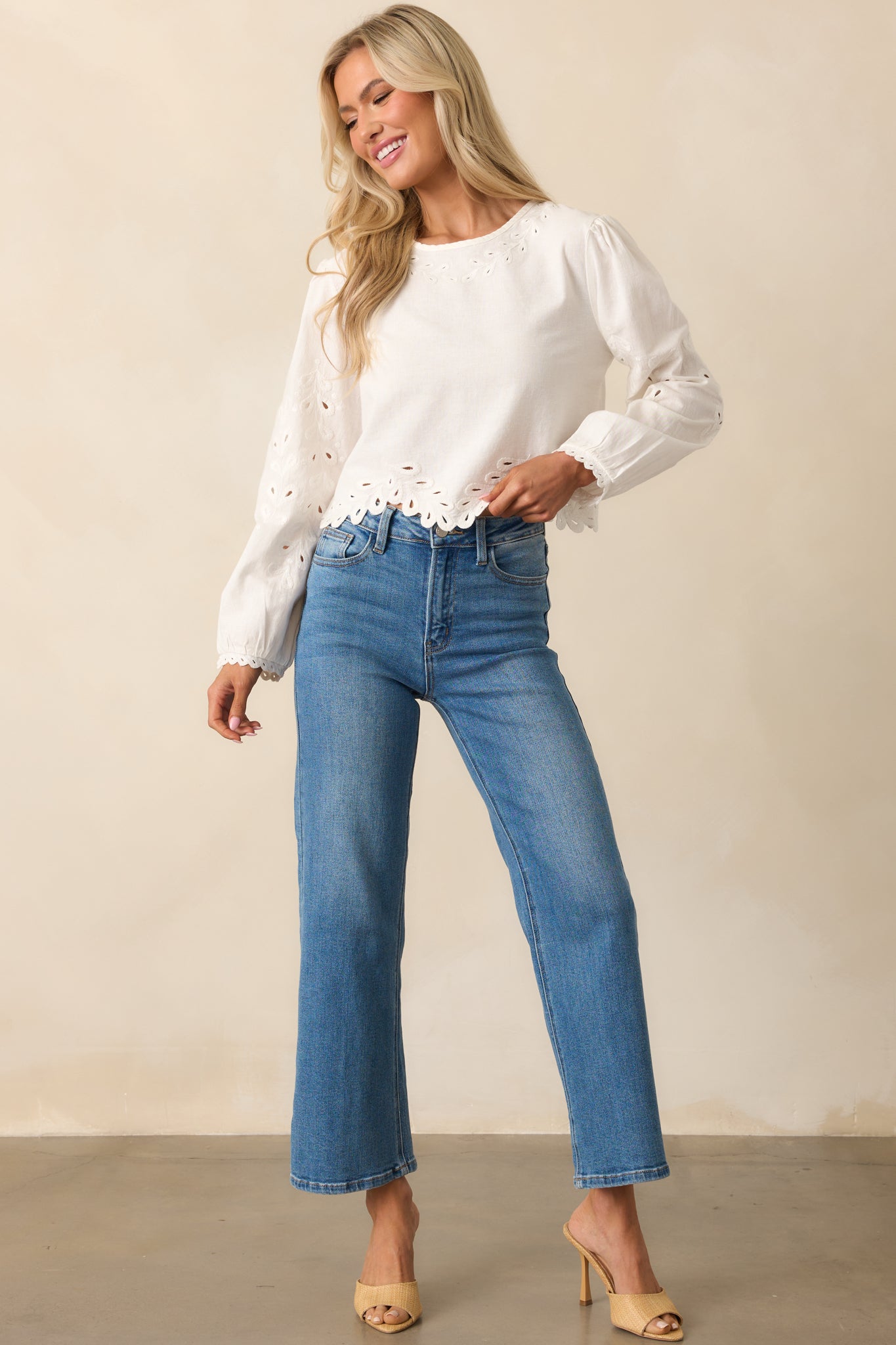 Full-body shot highlighting the cropped fit and lightweight fabric of the white puff-sleeve top.