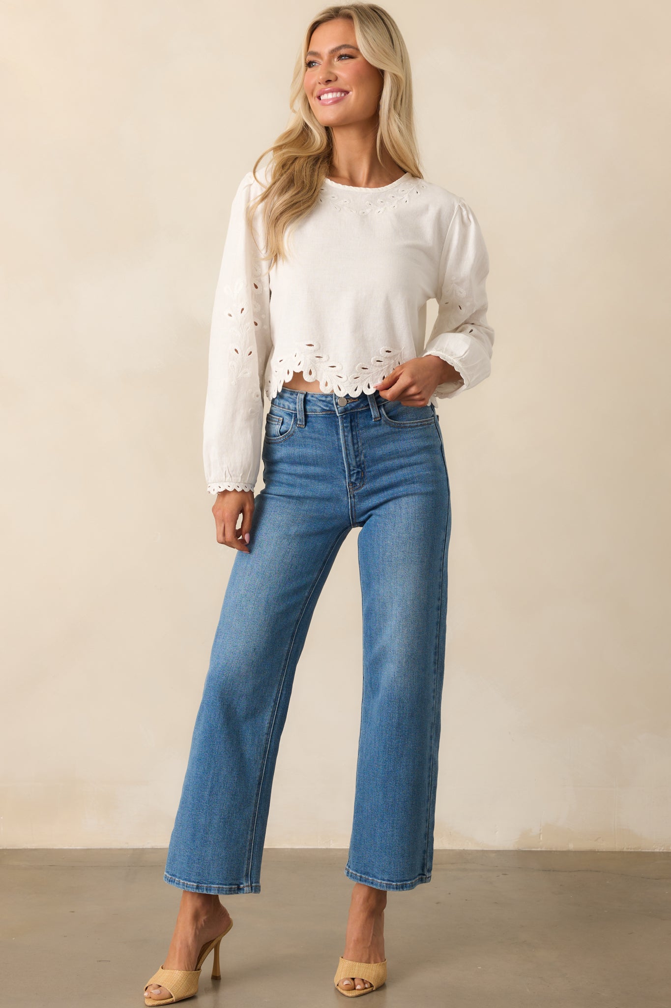 White embroidered top in a front-facing full-body view, showing the airy silhouette and round neckline