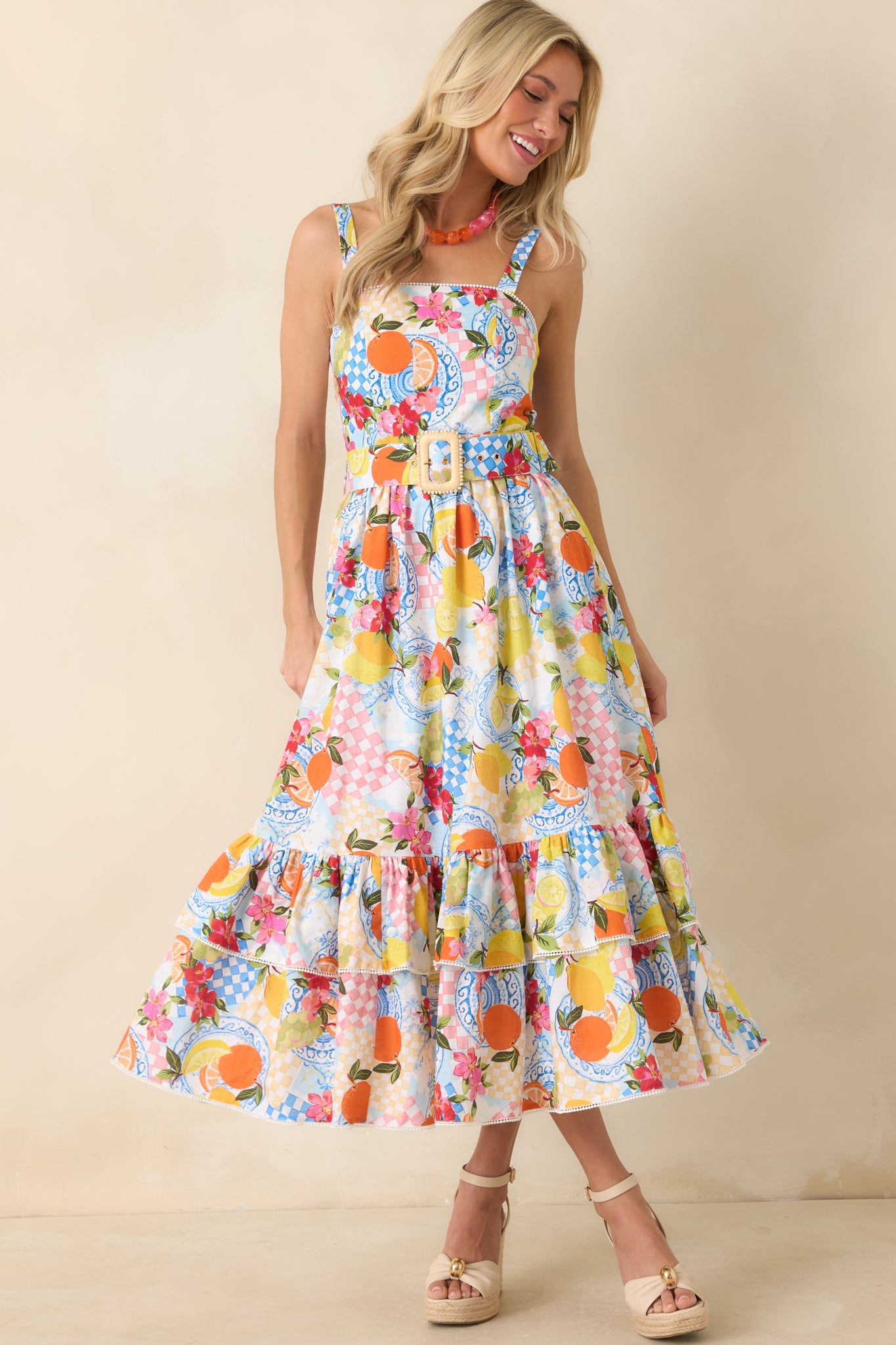 Full view of the multi citrus print midi dress in a linen-cotton blend, showing the square neckline, adjustable shoulder straps, and flowing tiered skirt in a relaxed silhouette.
