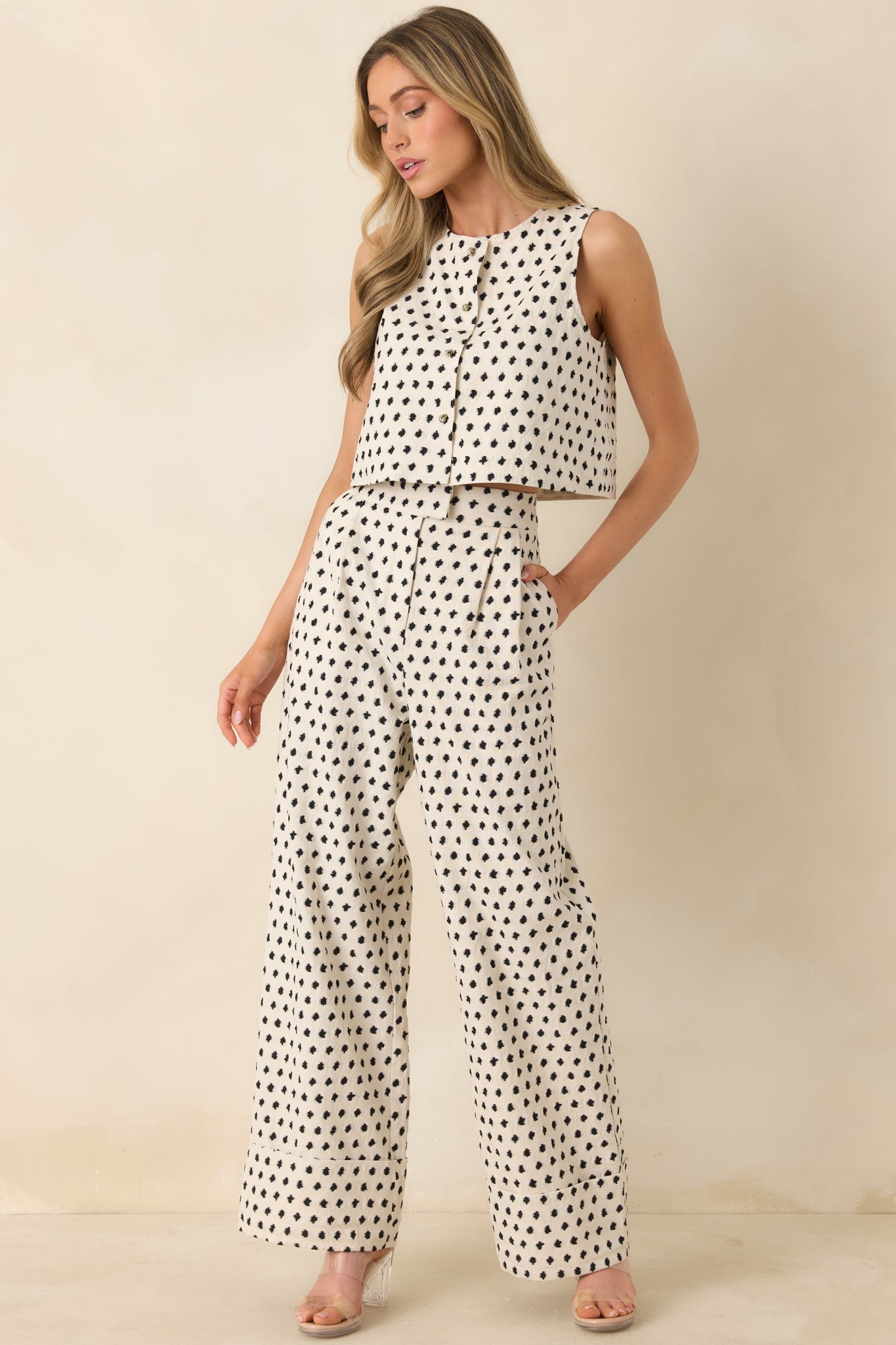 Relaxed wide-leg pants featuring cuffed hems, soft patterned fabric, and structured high-rise fit.