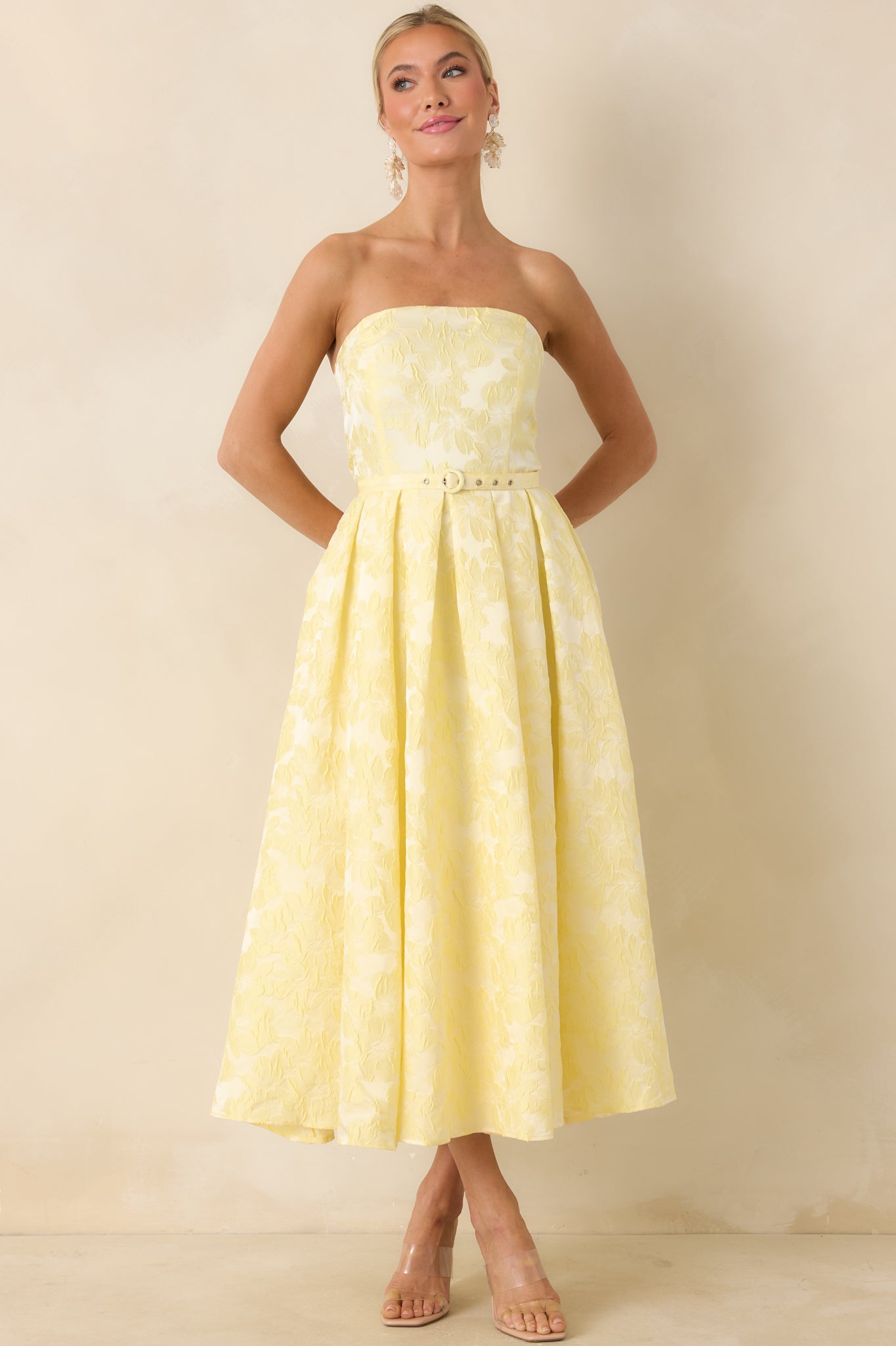 Romantic midi dress, with strapless neckline and flowing pleated silhouette.