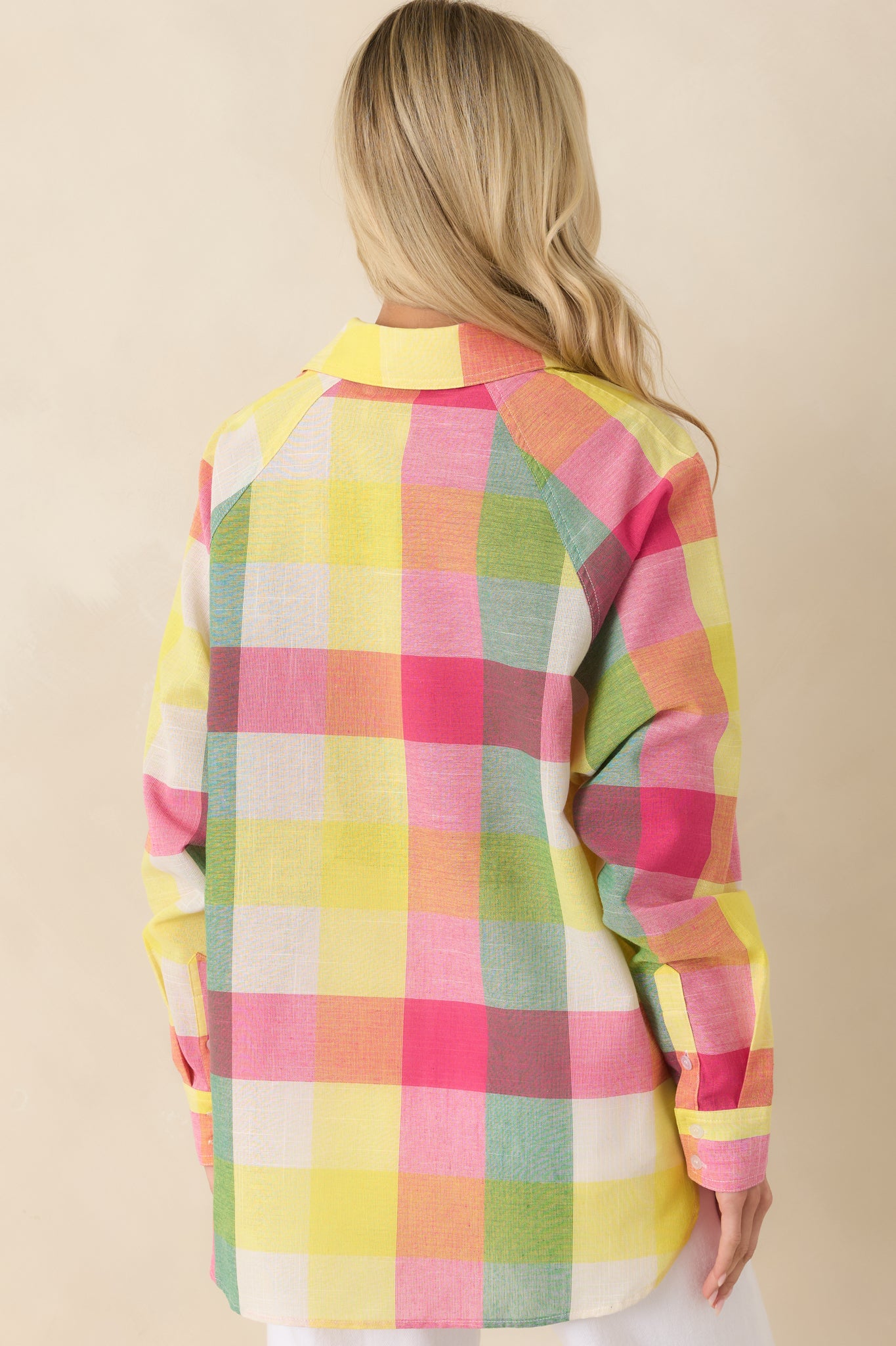 Rear view of the pink multi plaid shirt featuring a relaxed silhouette, long sleeves, and a rounded hemline.