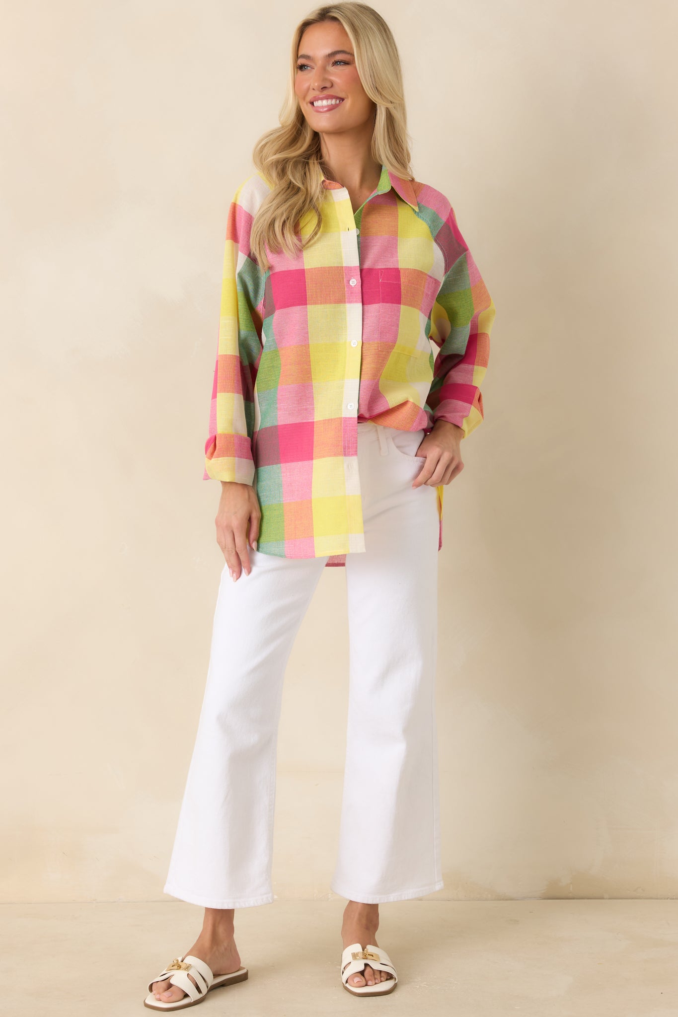 Pink and multicolor plaid woven shirt with a structured collar, full front buttons, and a casual rounded hem.