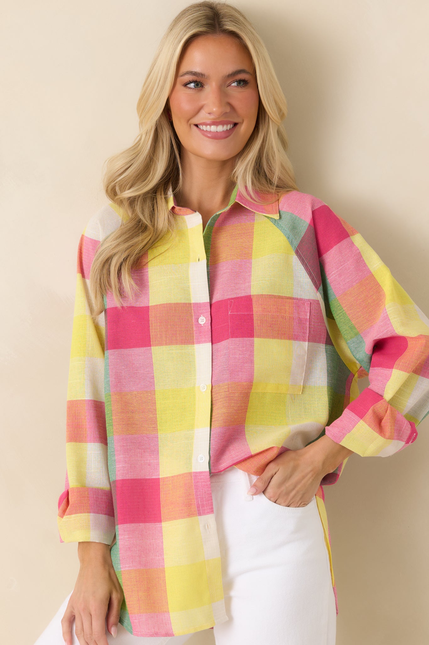 Close view of the relaxed-fit plaid shirt highlighting long sleeves and button cuff details.
