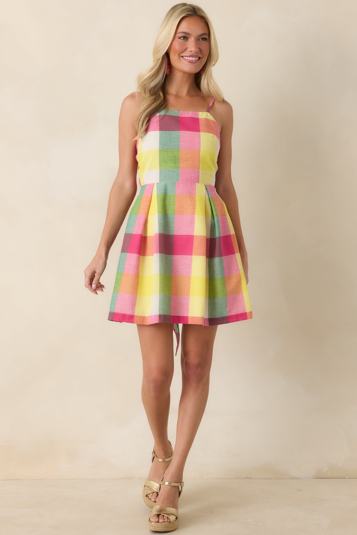 Colorful plaid mini dress showcasing a structured fitted bodice and breezy skirt shape.