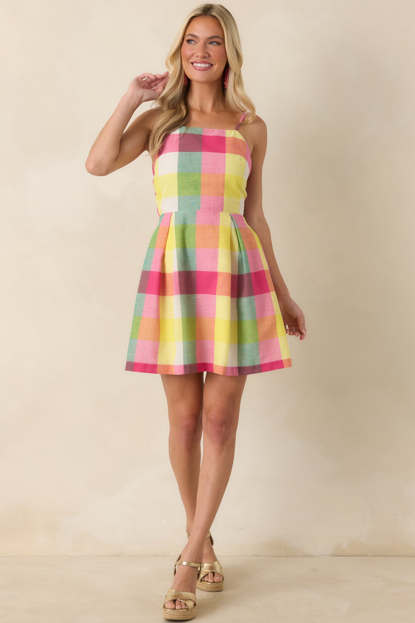 Multi plaid mini dress featuring a square neckline, fitted bodice, and flared skirt silhouette.