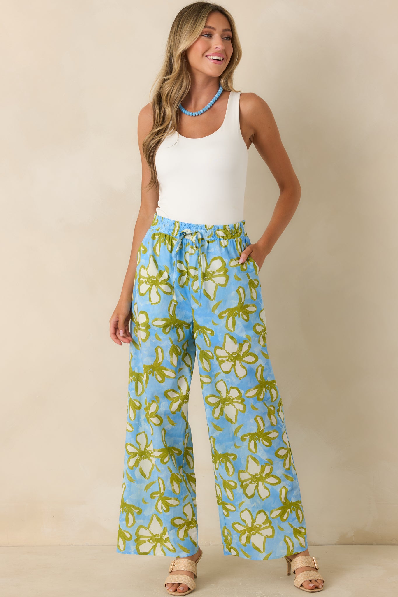 Floral wide leg pants with a vibrant botanical print, adjustable drawstring waist, and breezy full-length design.