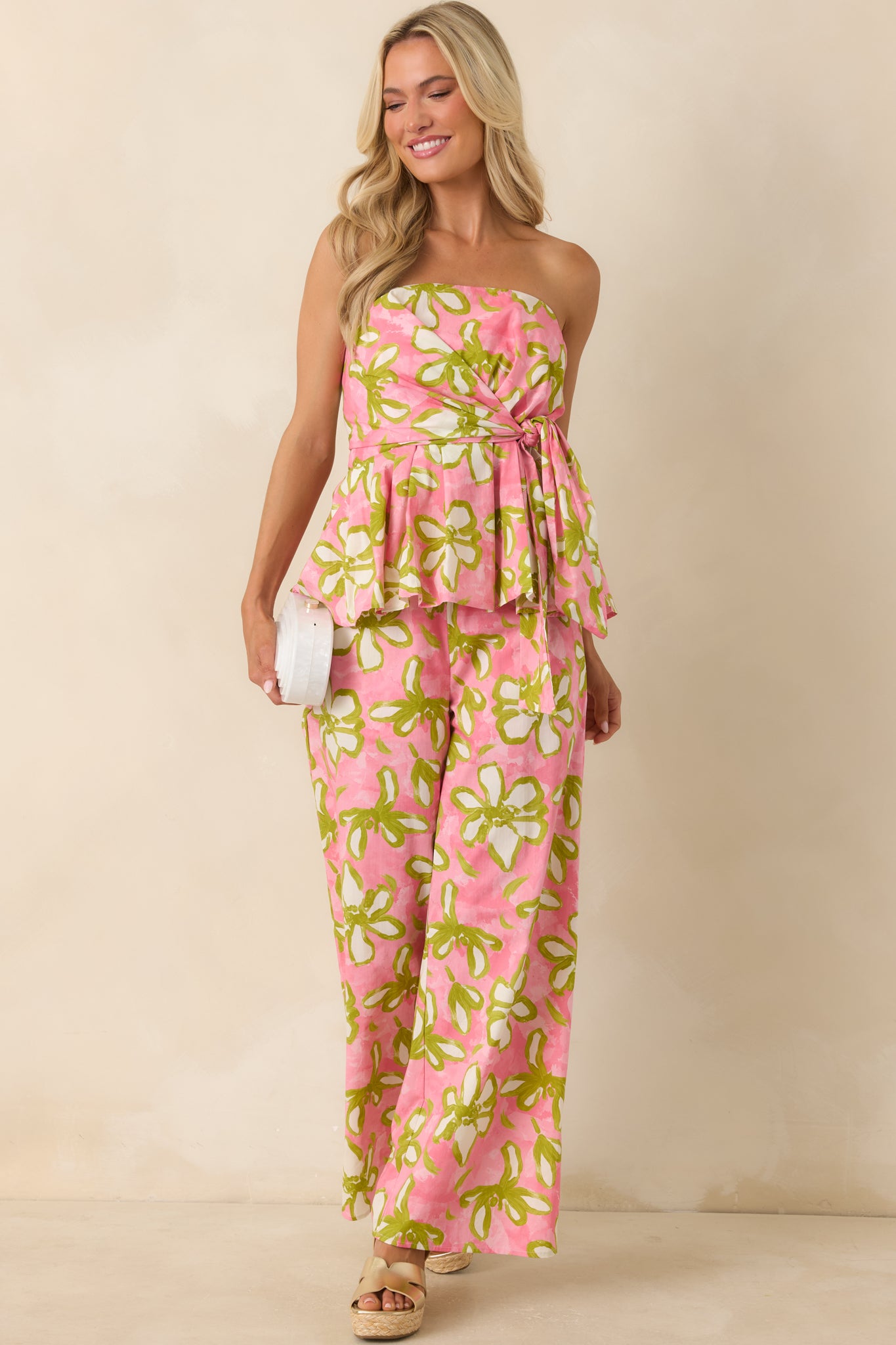 Bold floral peplum top with a flattering strapless neckline, fitted silhouette, and colorful retro-inspired botanical pattern.