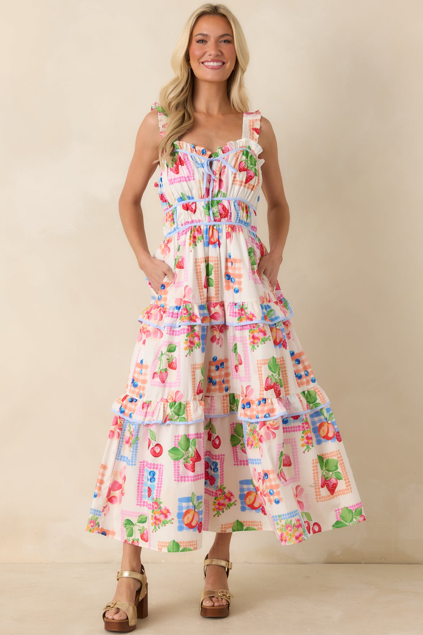 Multi-color maxi dress featuring a fruit and floral patchwork-inspired print, ruffled shoulder straps, and a sweetheart neckline with front tie detail.