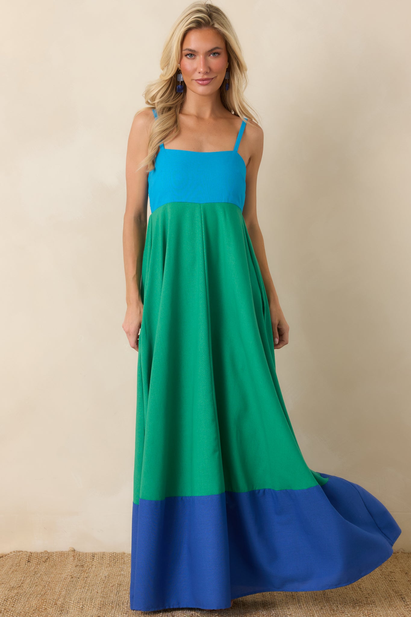 Lightweight maxi dress with a fitted bodice, square neckline, and relaxed full-length silhouette with hidden side pockets.