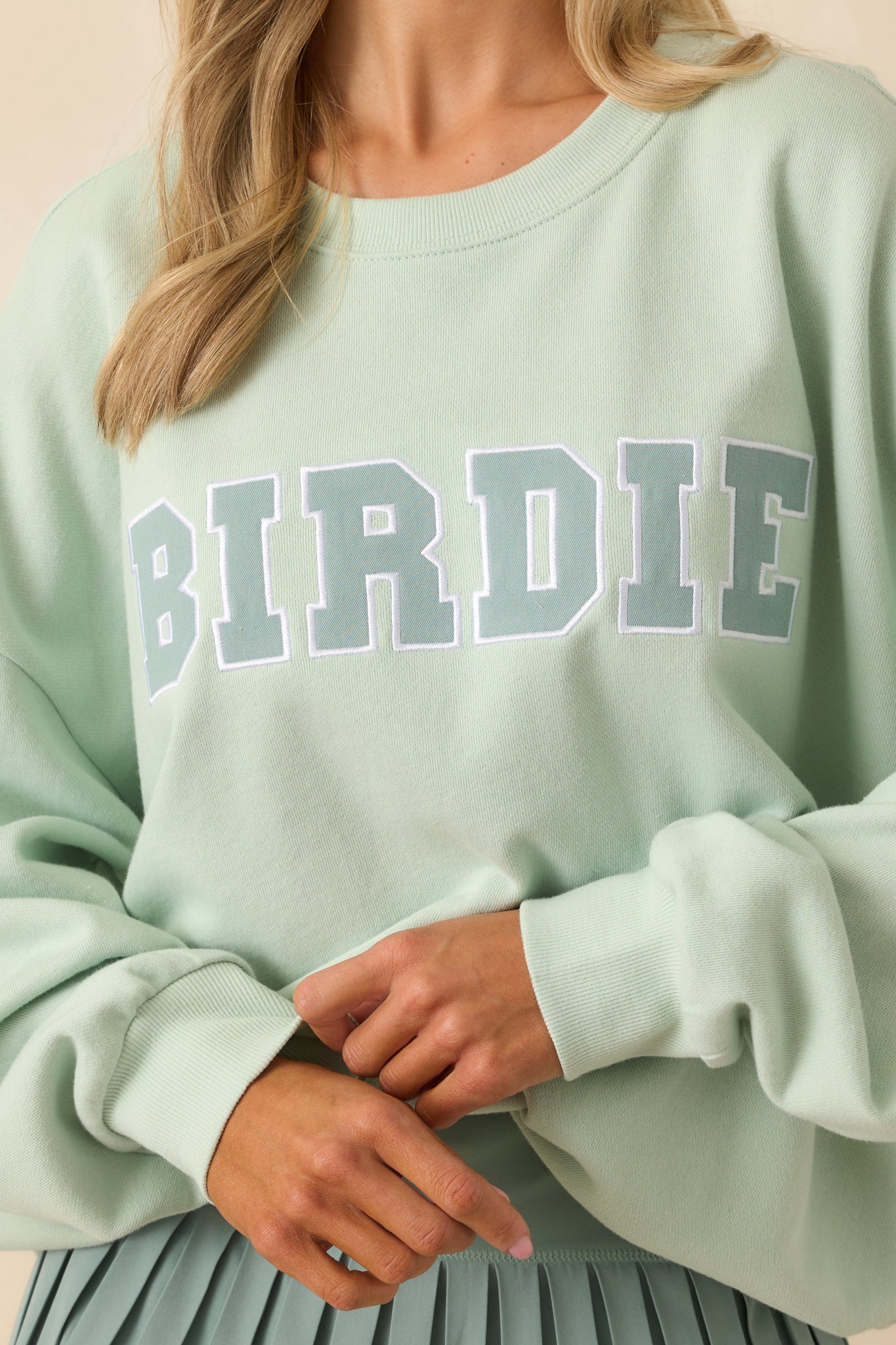 Close-up of the "Birdie" embroidery showing stitching detail and texture of the fabric.