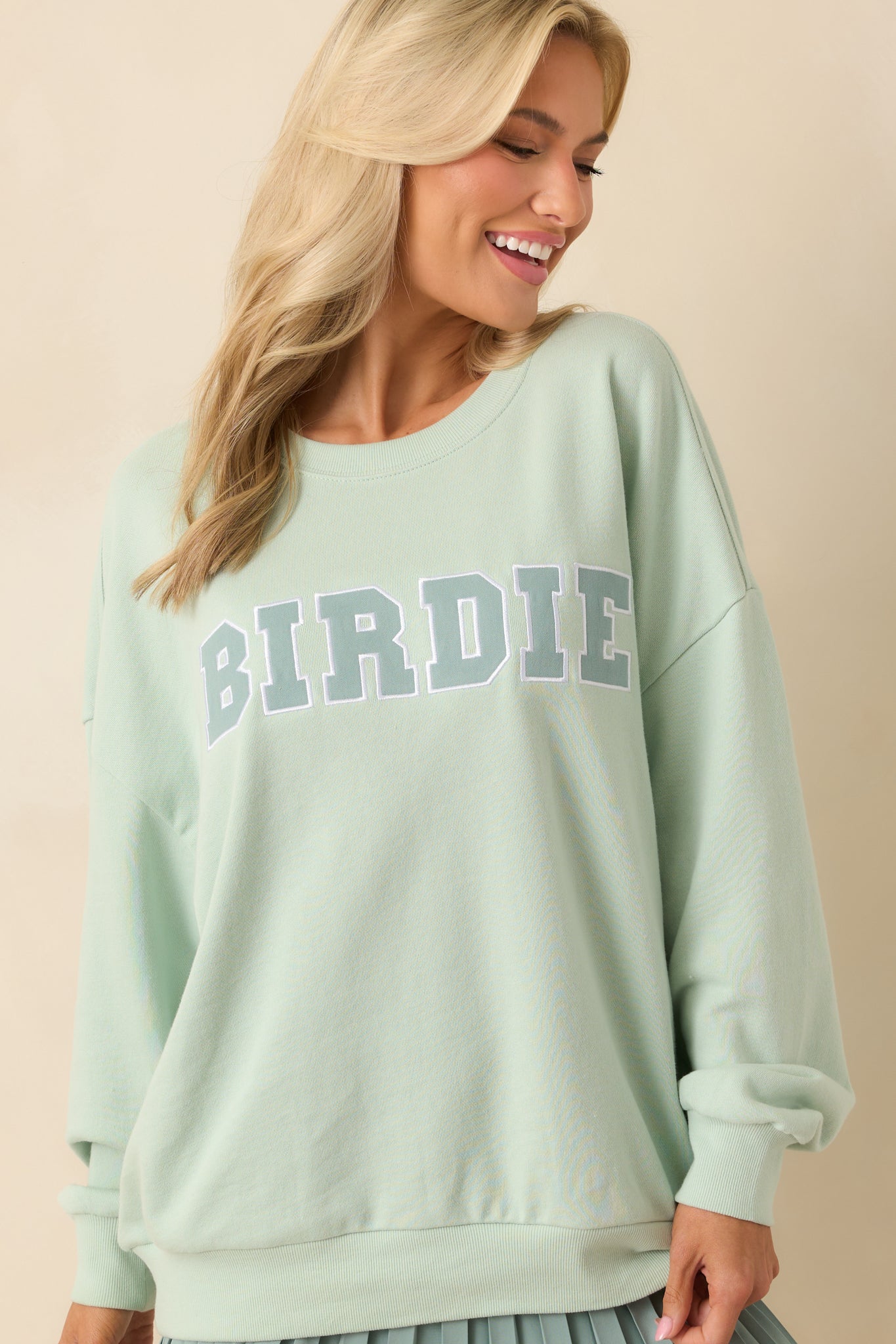 Cropped lower half of the sweatshirt highlighting the oversized hem and relaxed structure.