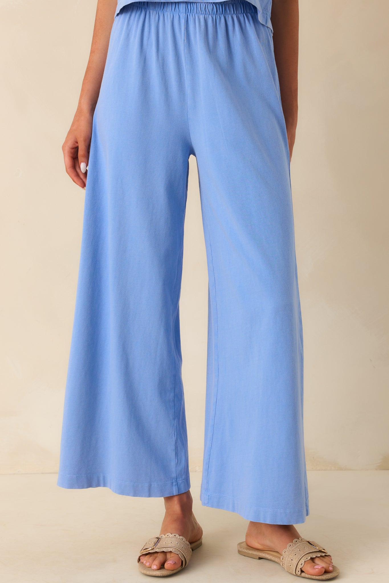 Cropped shot of the lower leg and hem, showing the full width of the wide leg opening.