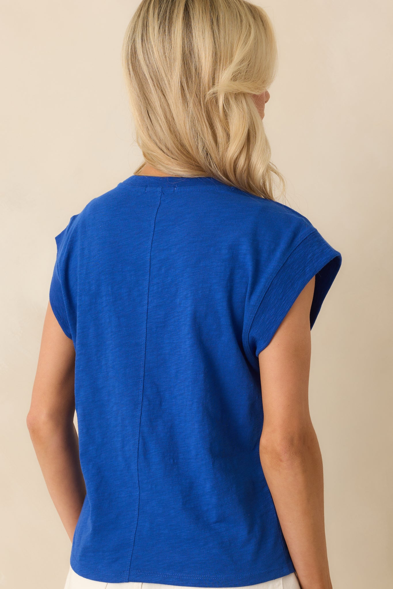 A view from behind featuring the center seam detail and the continued relaxed fit of the tee.