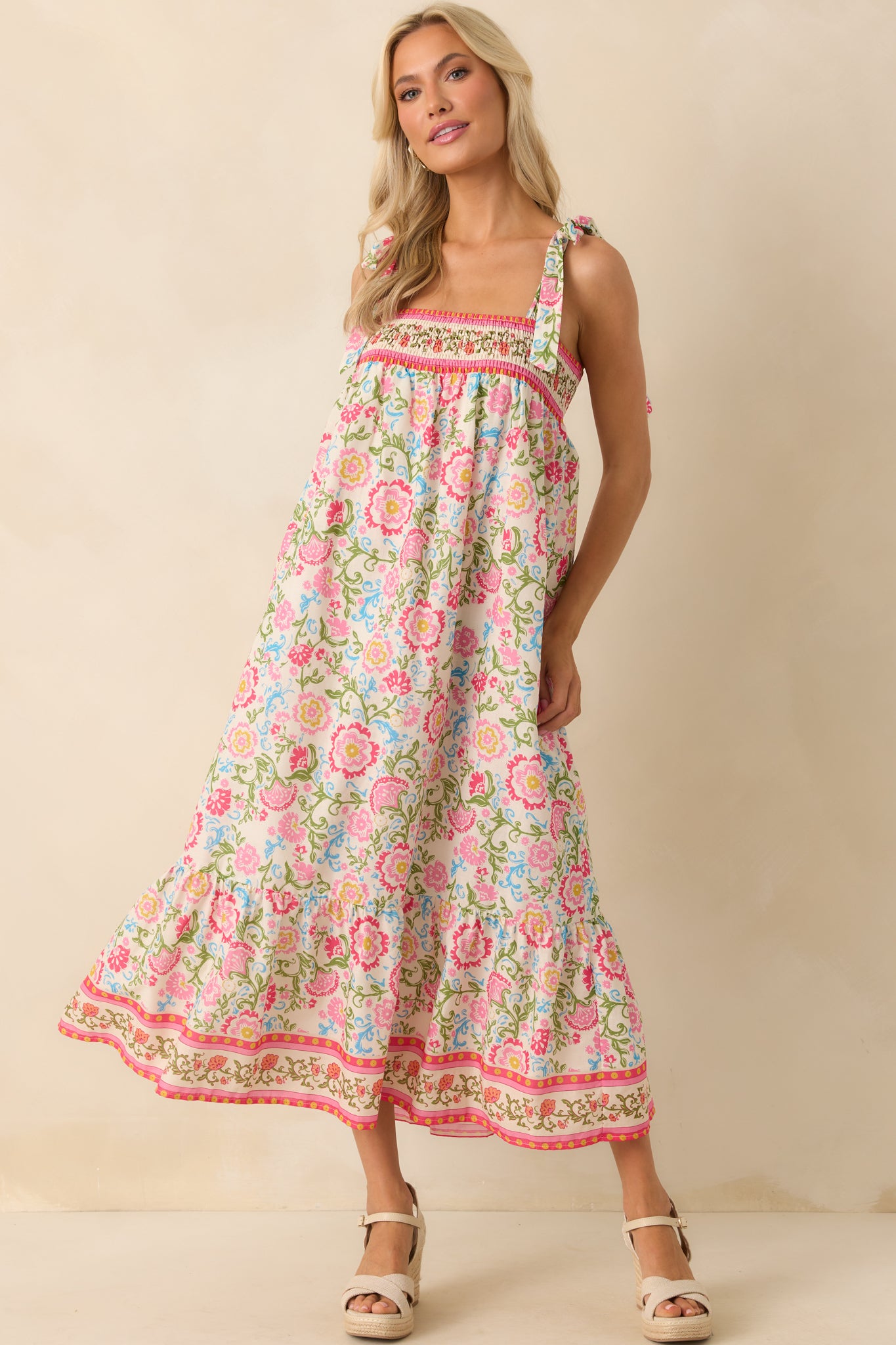 Pink floral maxi dress shown in a full-length view, focusing on the relaxed fit and vibrant print.