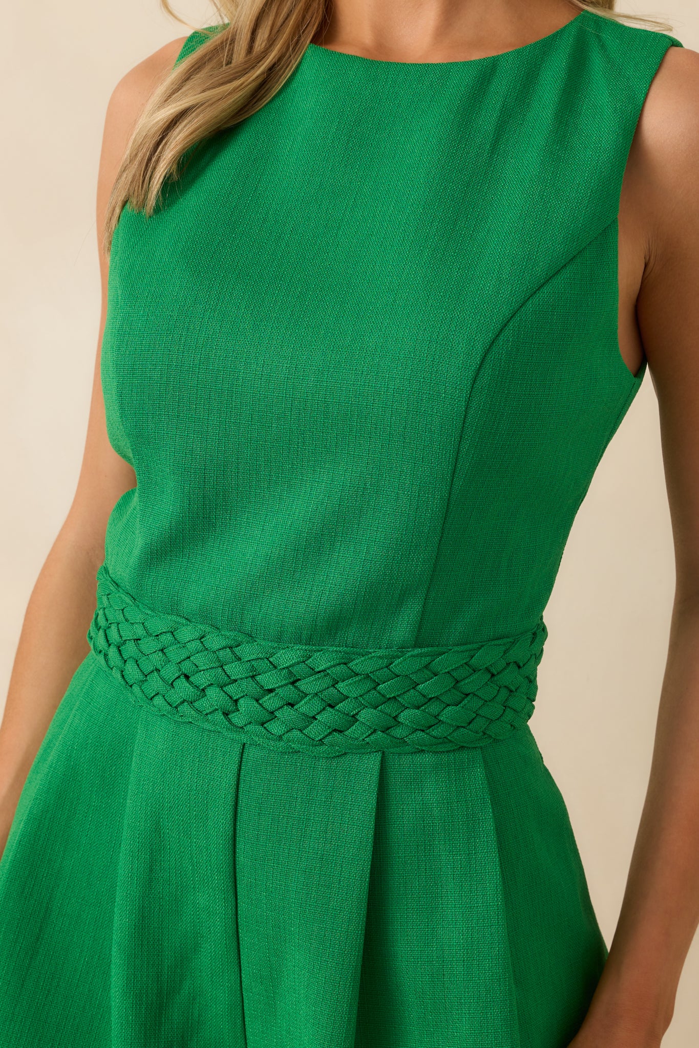 Close-up detail of the waistband texture and pleating, with a clear view of the woven braiding.