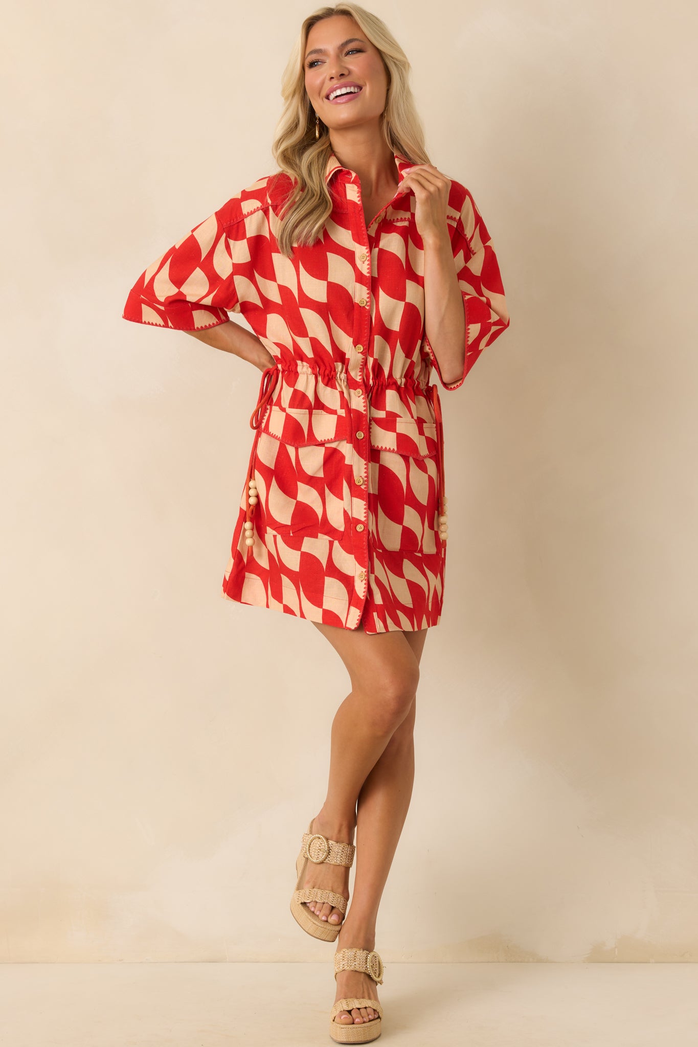 Full body angle highlighting the oversized short sleeves and drawstring waist with wooden bead tassels.