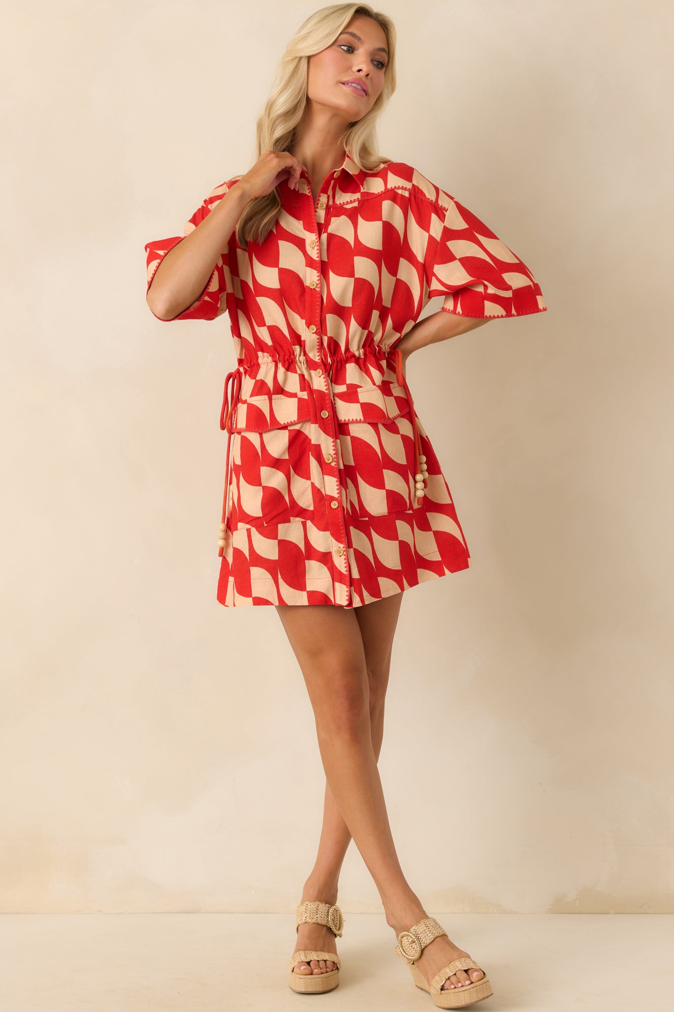 Full body view emphasizing the functional wooden button front and relaxed silhouette.