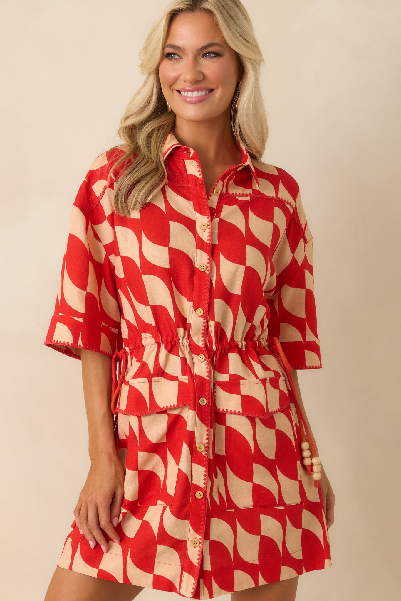 Cropped view highlighting the short sleeve and contrast blanket stitch along the hem.