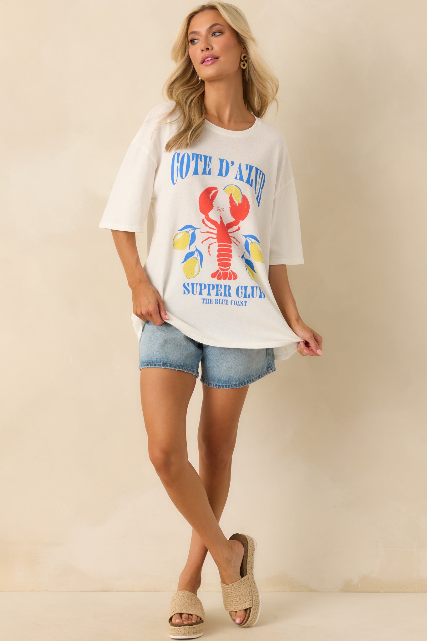 Full body view with arms slightly lifted, showing the lightweight nature and oversized silhouette of the tee.