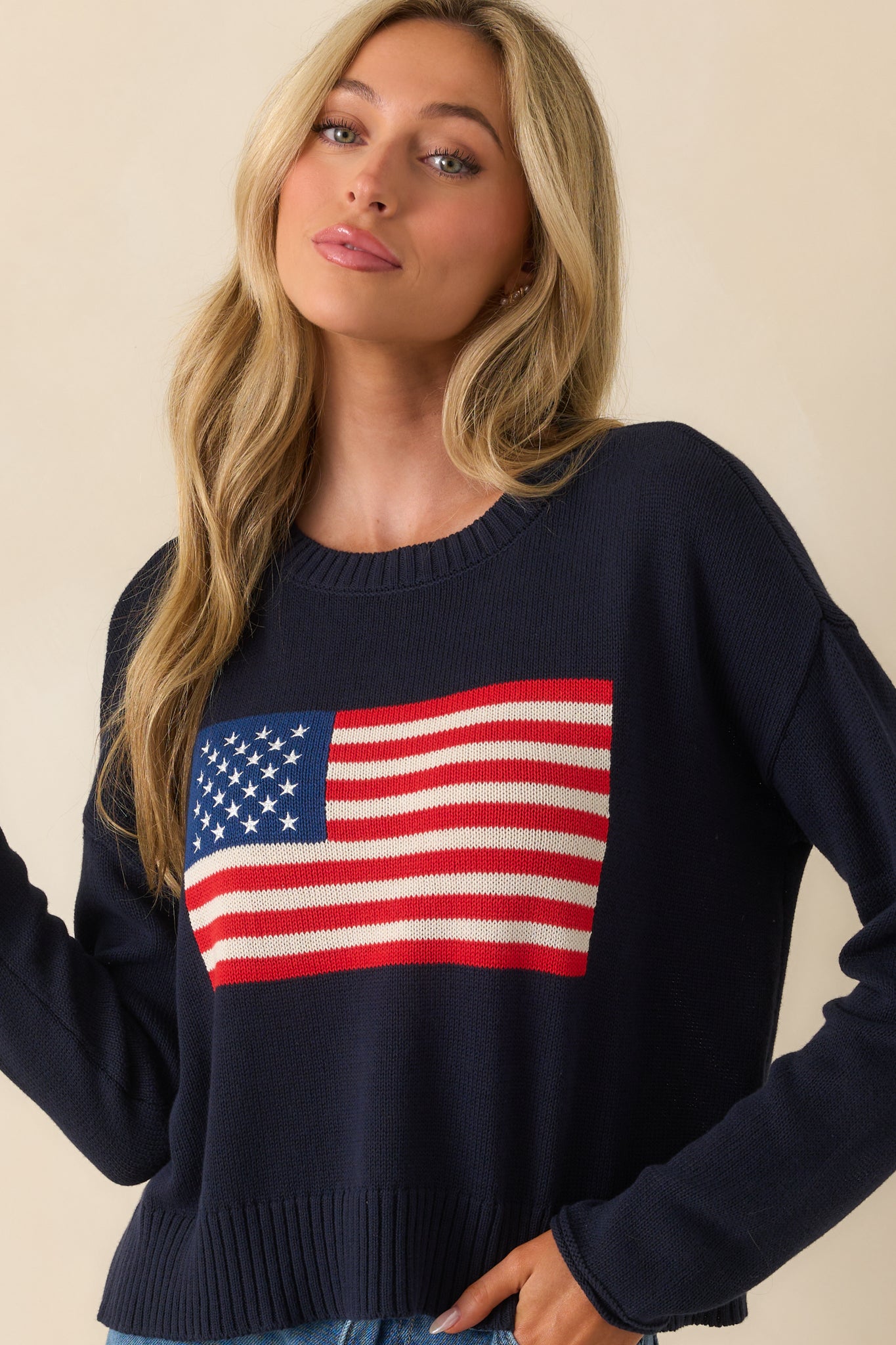 Lower cropped view highlighting the relaxed hemline and subtle structure of the knit.