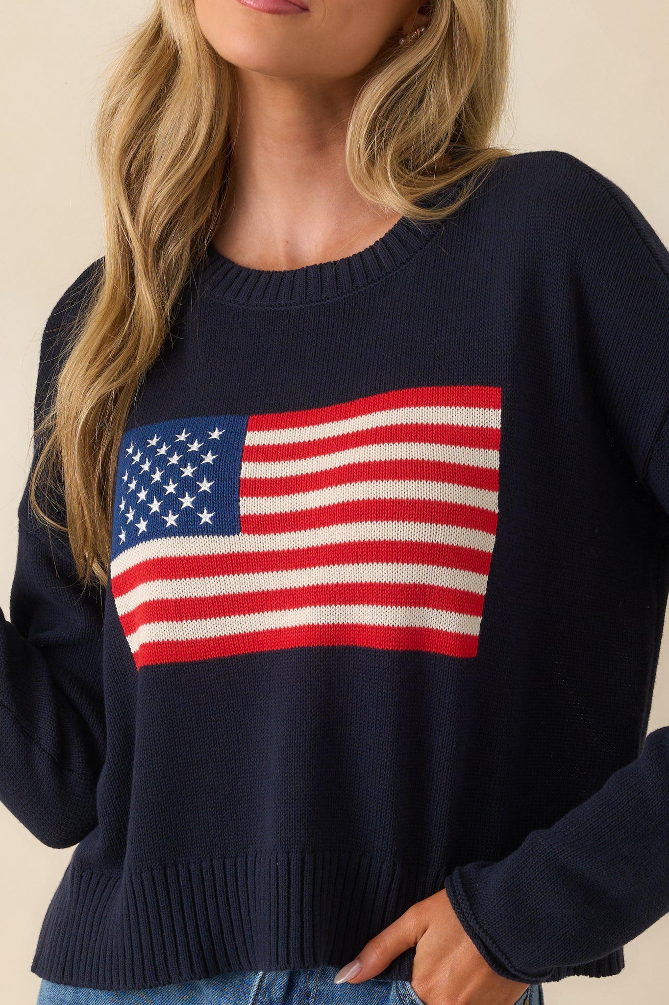 Extreme close-up of the knit American flag motif, showcasing the stitching and raised texture of the yarn.