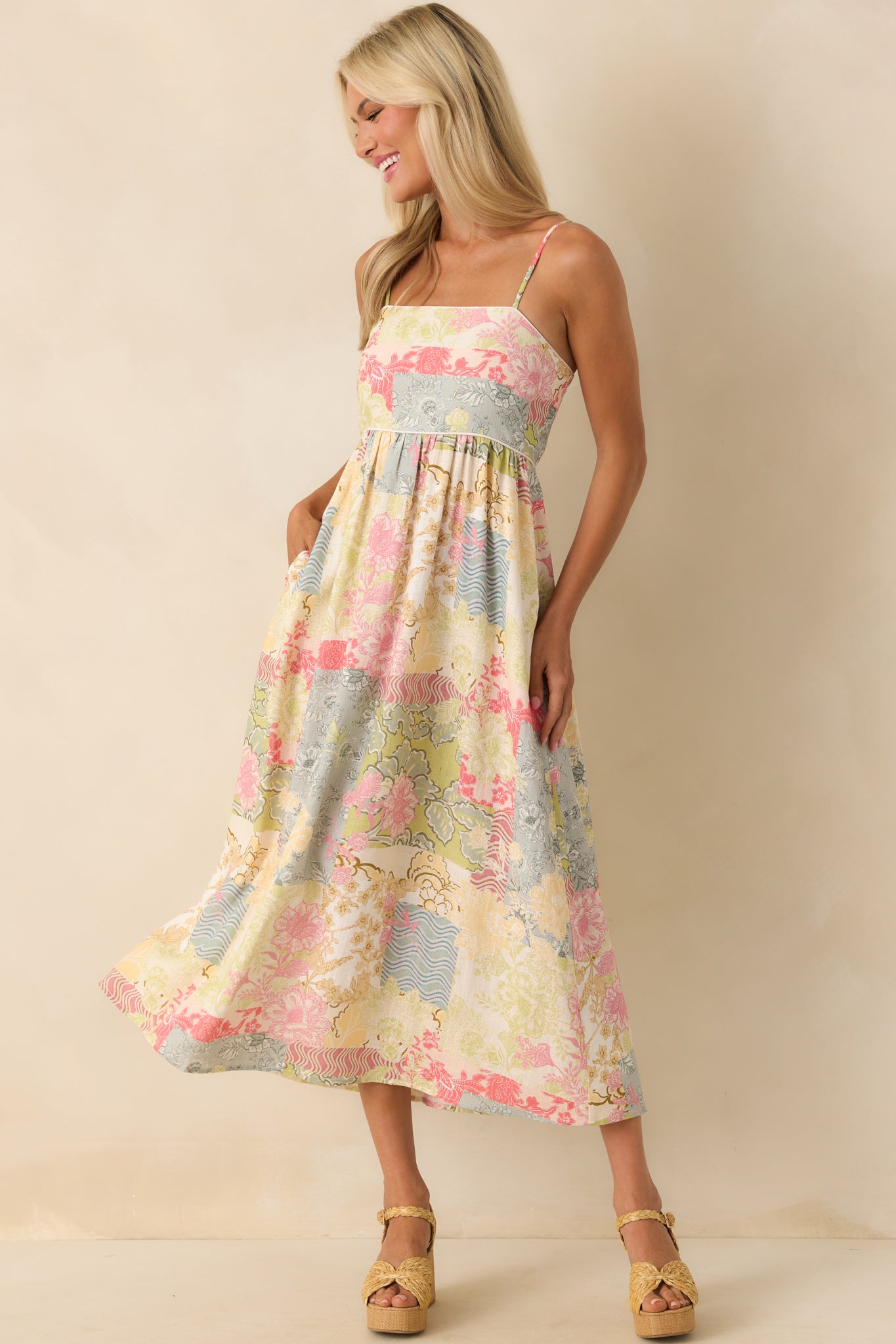 Front view of the midi dress featuring a multicolor patchwork print, square neckline, and ivory piping along the bodice seams.