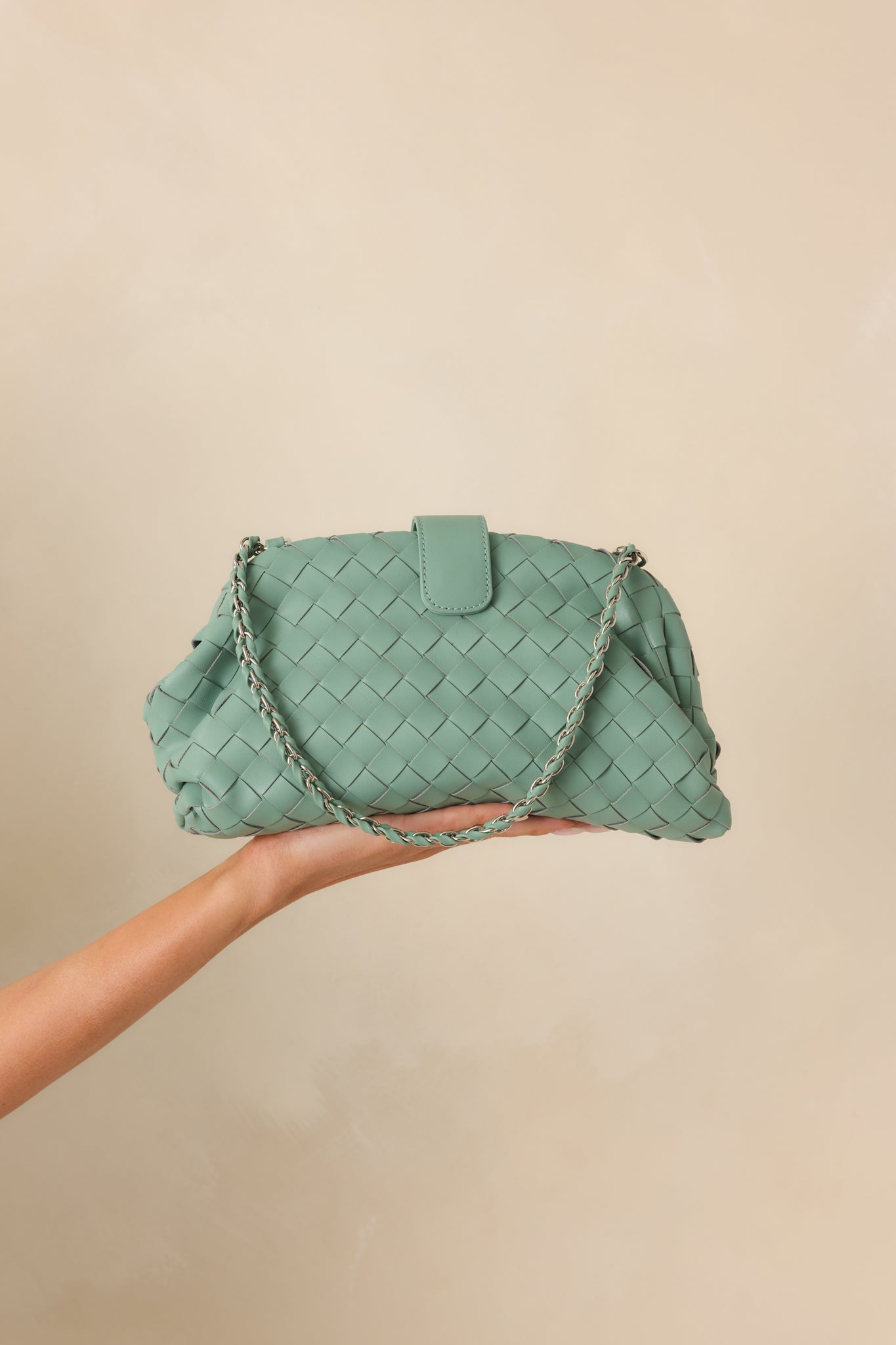 Front view focusing on the magnetic flap closure and overall woven texture of the handbag.