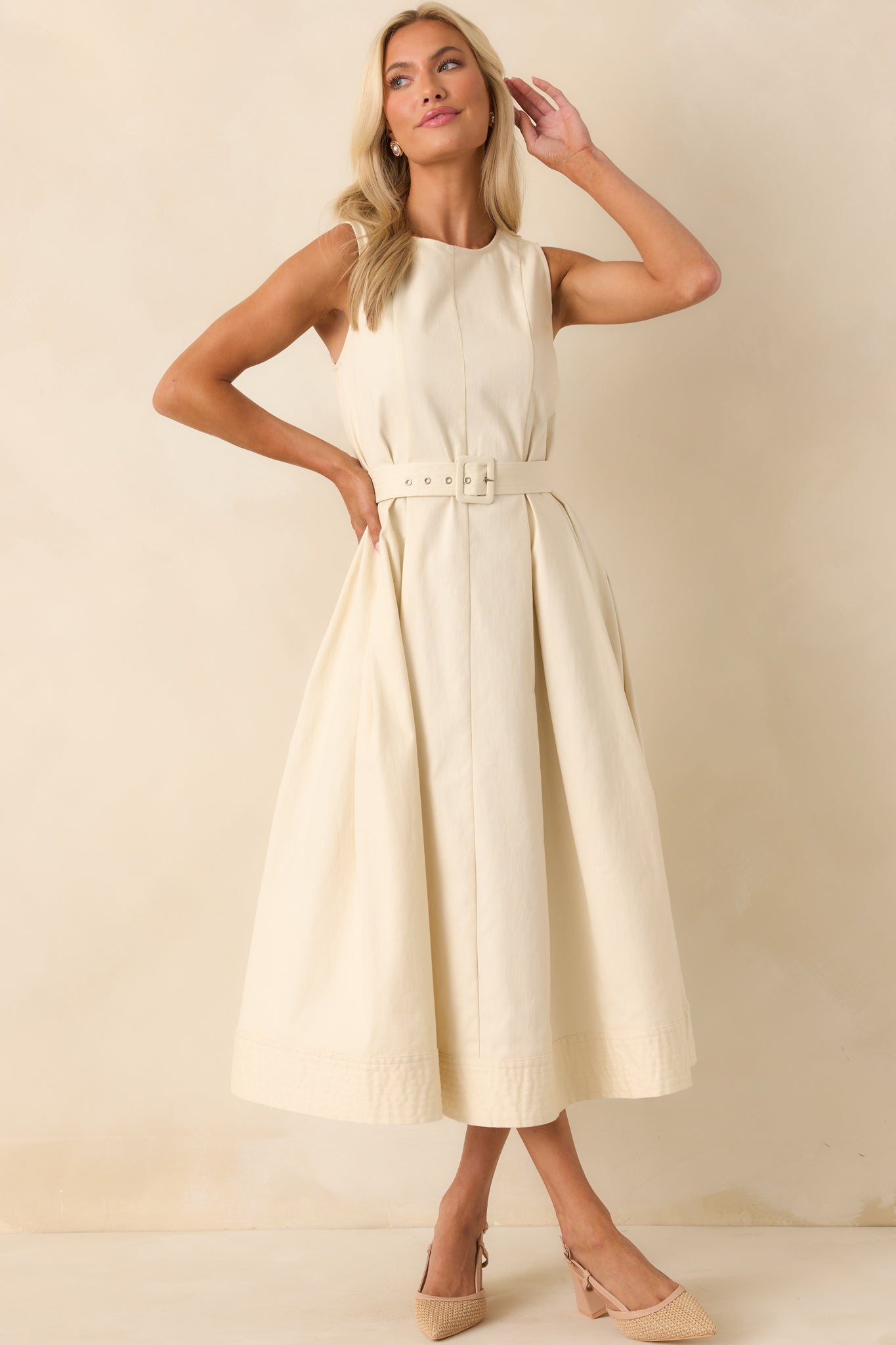 Full body front view of the ecru dress highlighting the rounded neckline and belted waistline.