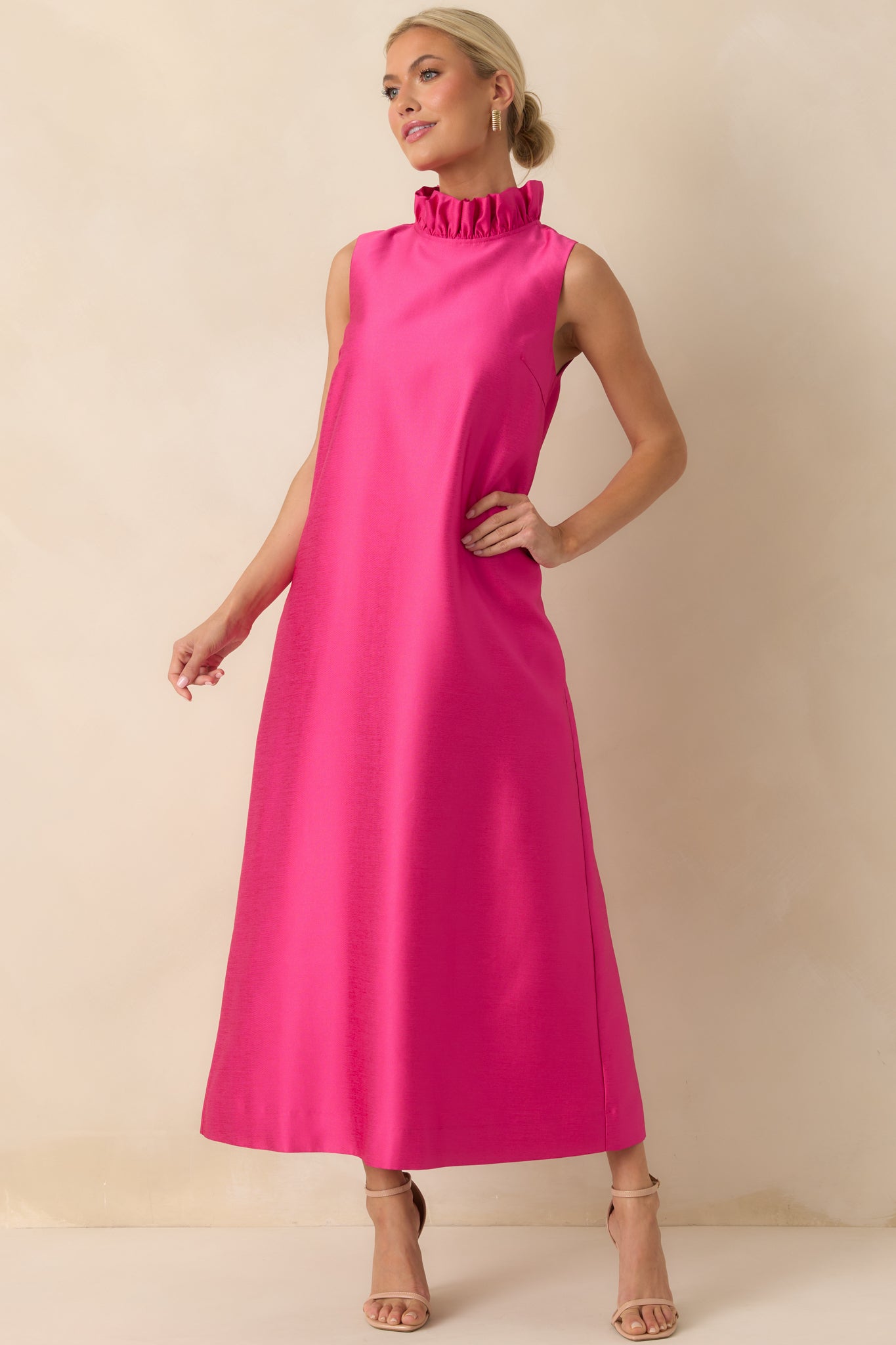 Flowing hot pink maxi dress highlighting the sleeveless design and soft drape for a relaxed silhouette.