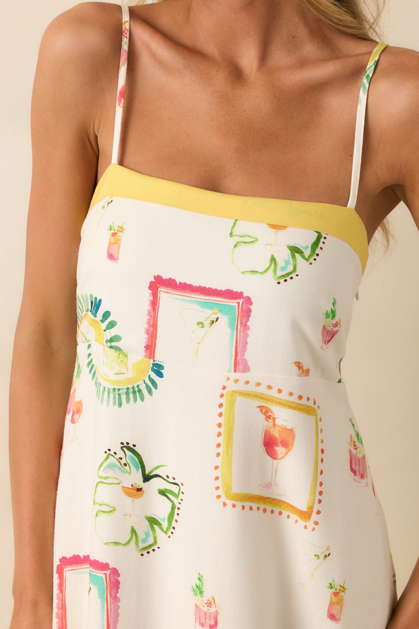 Close-up of the top of the dress showing the square neckline, adjustable straps, and fine detail in the watercolor cocktail print.