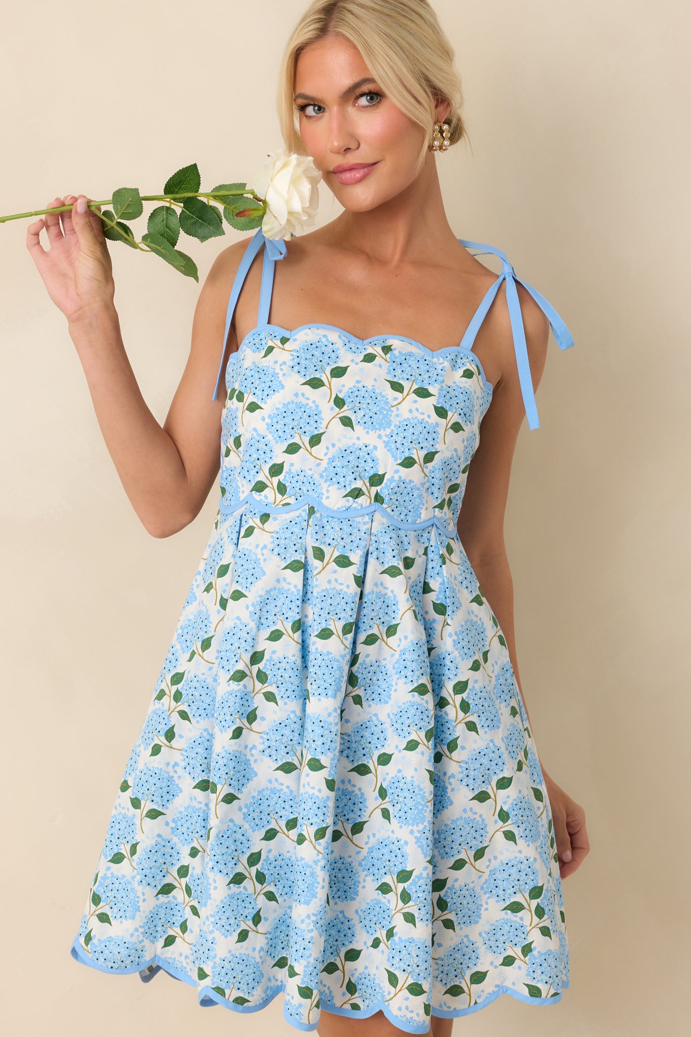 Cropped view of the bodice showing the tied bow straps and upper portion of the blue hydrangea print.