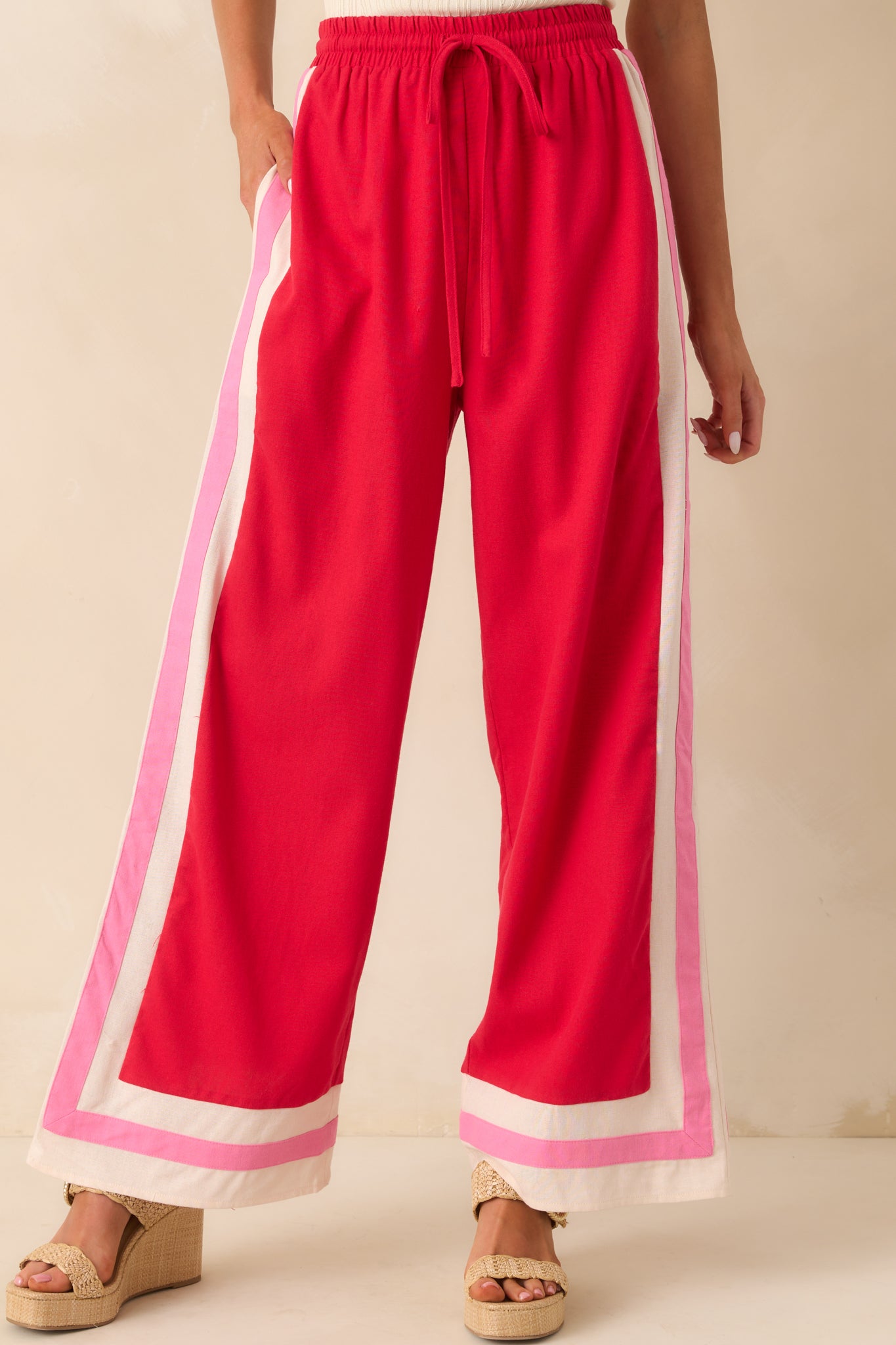 Cropped front detail focusing on the waistband, drawstring tie, and contrast trim near the pockets.