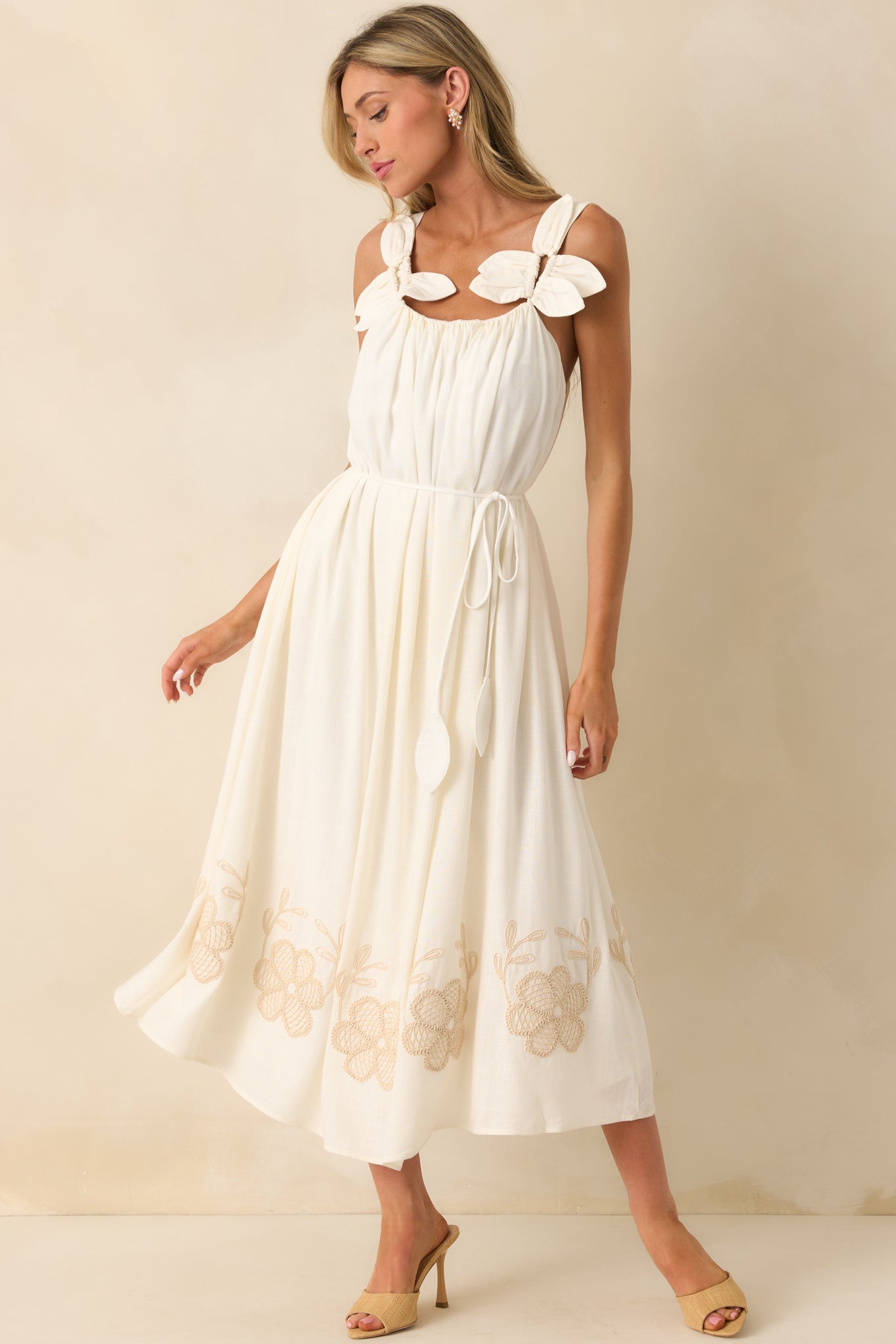 Front-facing full view of the ivory maxi dress featuring a scoop neckline, 3D flower petal applique straps, and a flowing linen blend fabric.