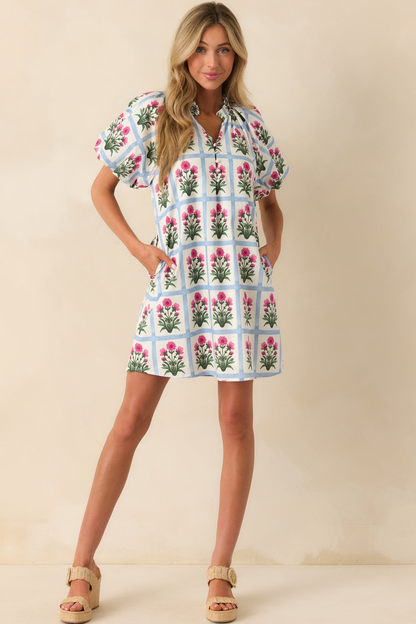 Full body view of the mini dress showcasing the light blue geometric grid print with dark fuchsia floral motifs and a relaxed silhouette.