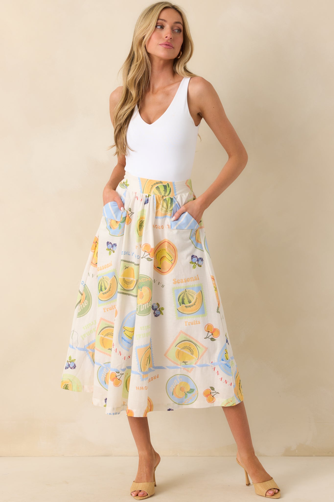 Ivory midi skirt with Prosperina multicolor patchwork print, shown in a full-length view highlighting the skirt’s silhouette.
