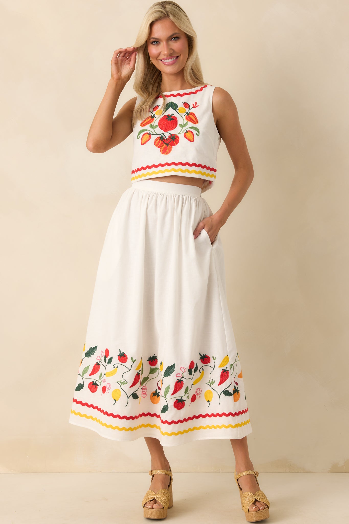 Front view of lightweight cotton-linen skirt featuring two ric rac stripes beneath the embroidered section and functional pockets.