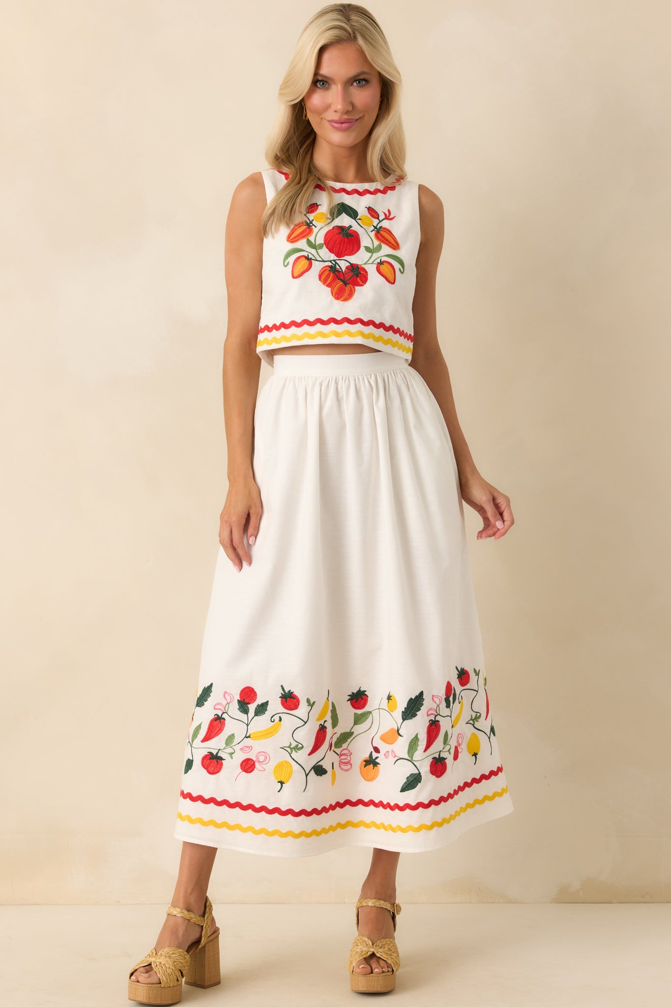 Maxi skirt displayed in full with visible elastic back waist insert and soft drape of the ivory fabric.